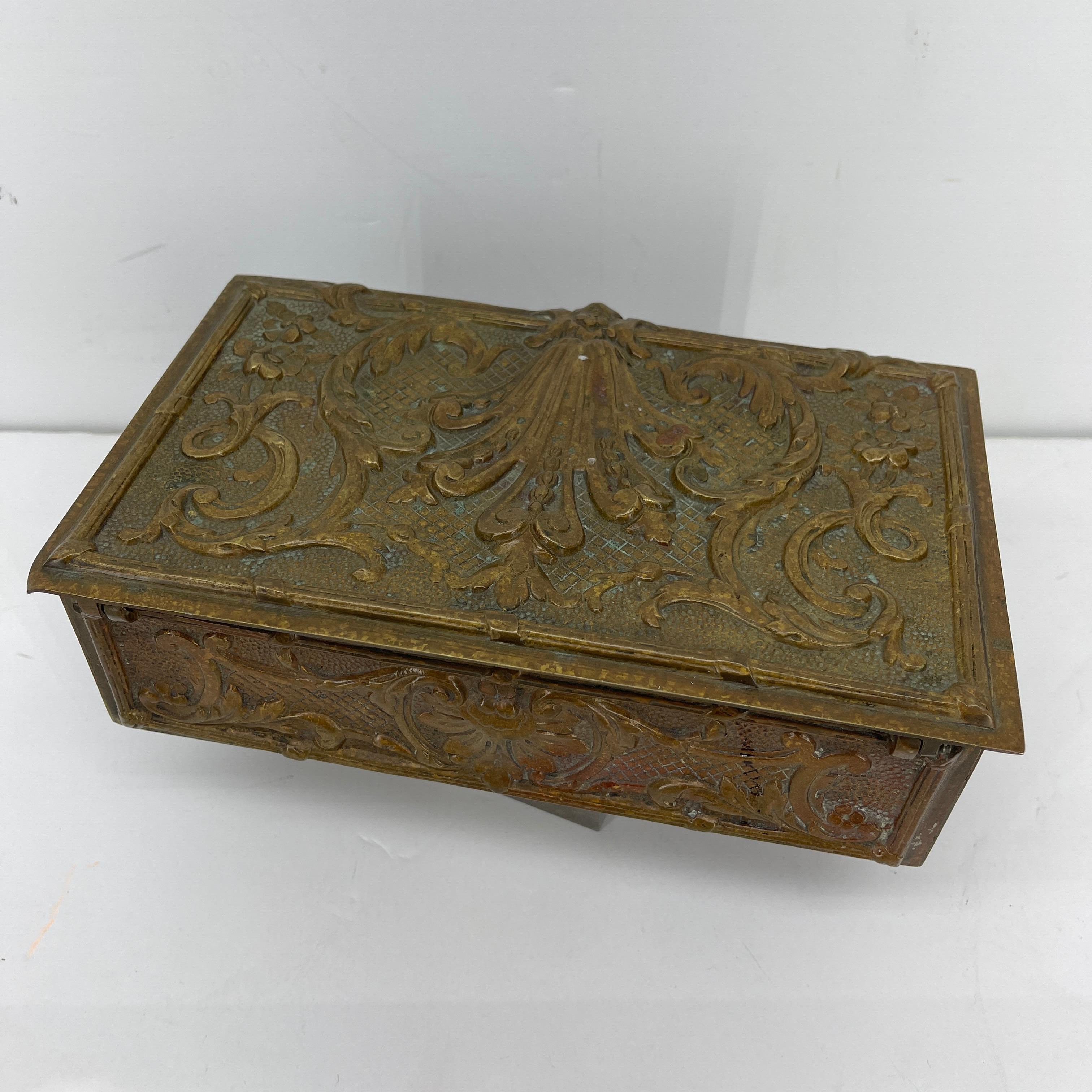 Rare bronze vanity or jewelry box made in Belgium in the early 1900's.
This rectangular bronze box is prominently cast with Rococo decor on all sides and on the lid. The interior is wooden and stamped Made in Belgium. Perfectly sized for a vanity