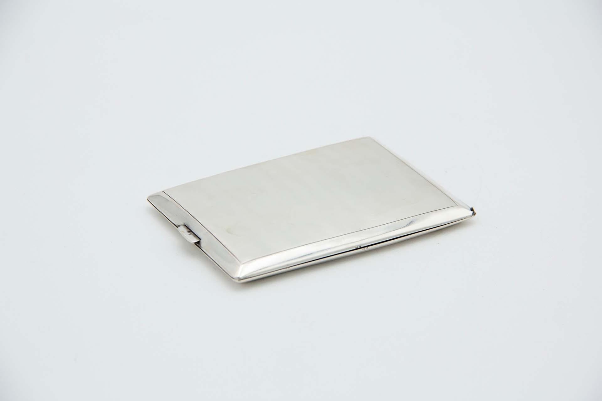 Description: Brushed silver cigarette case, rectangular in shape with beveled edges. Metal: Silver. Origin: Portuguese. Brand: javali II Title. Weight: 106.98 grams. Dimensions: 11.5cmx1cm. Content: 833/1000. Assay Mark: Yes, between 1887 and 1937.