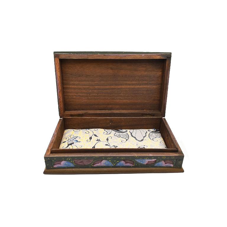 A beautiful rectangular Sumatra hinged box with a Phoenix bird motif. An excellent piece to display on a coffee table or side table. This lovely box features a colorful phoenix (or peacock) carved at the top and decorated in an array of purples,