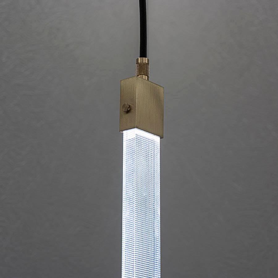 In this elegant brass and polycarbonate rectangular ceiling lamp, simplicity of design hides the complexity of details. It harkens back to the famous Star Wars laser sword, with exquisite fine lines where light reflects on the inside. The light is