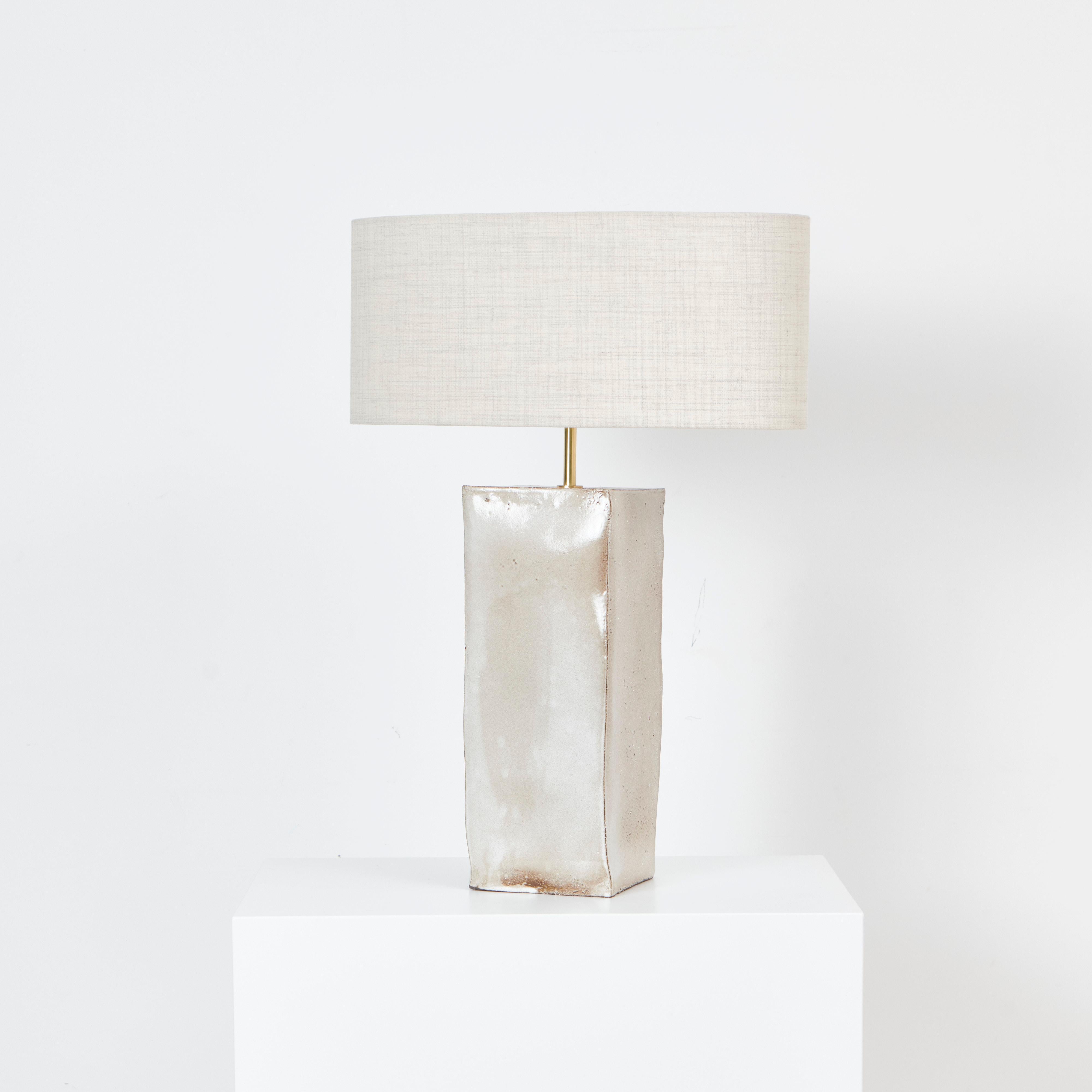 Rectangular Ceramic Light 
Designed by Project 213A in 2023

Artisanal ceramic light with a rectangular base, made in Project 213A's own ceramic workshop. It has a brass stem and a oval shaped lampshade made from 90%wool, 10% worst nylon.
Each piece