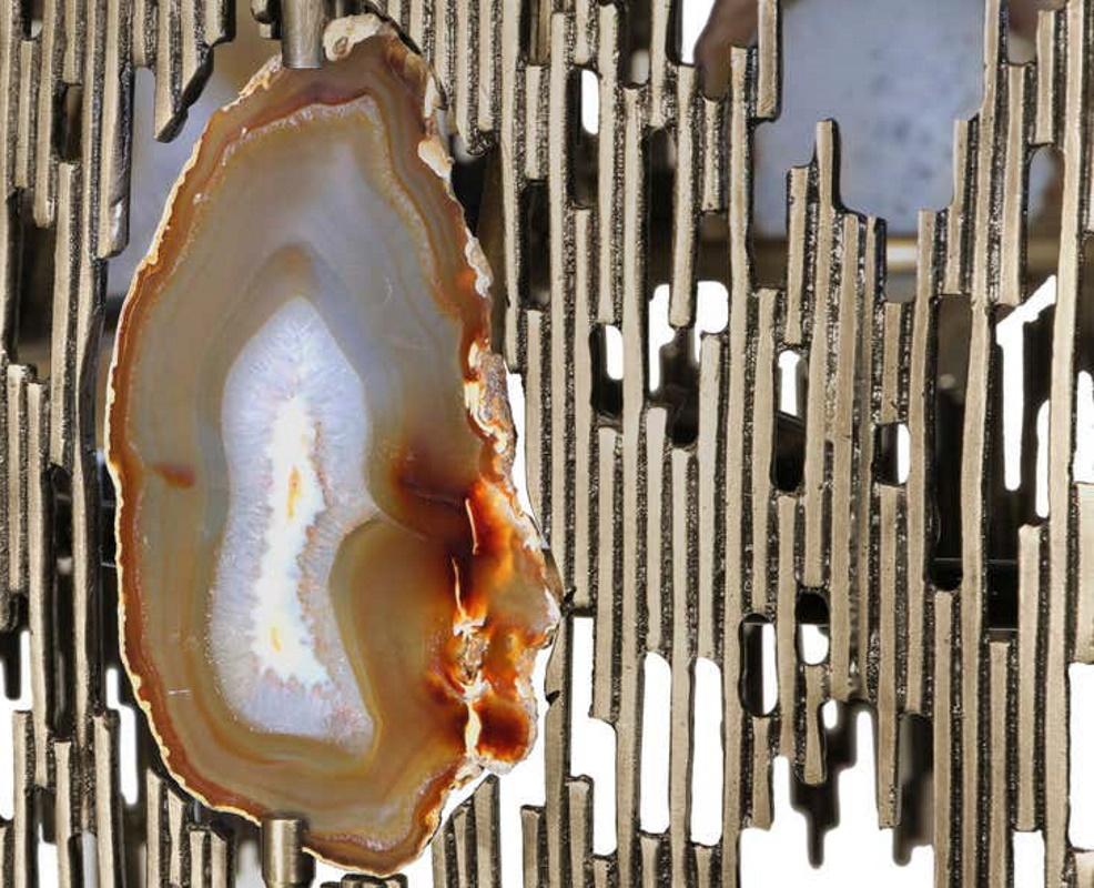 The dark neutral tones and the exquisite patterns in the agate stones are uniquely captivating against the light and the gold metal which embraces each stone in perfect harmony and balance. Hand-selected agate slices offer the perfect glow when the