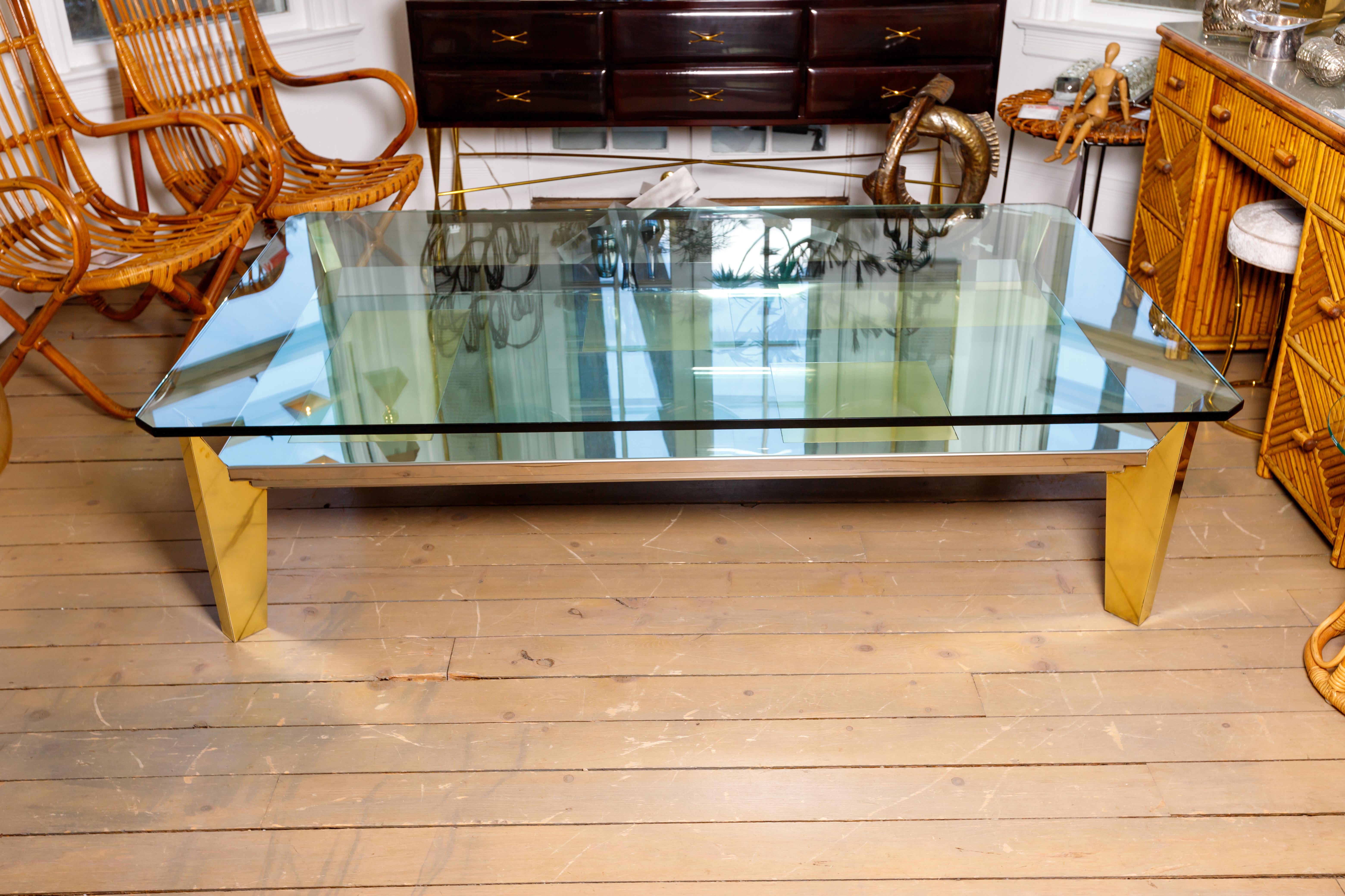 Glass top coffee table - chrome with brass inlays.