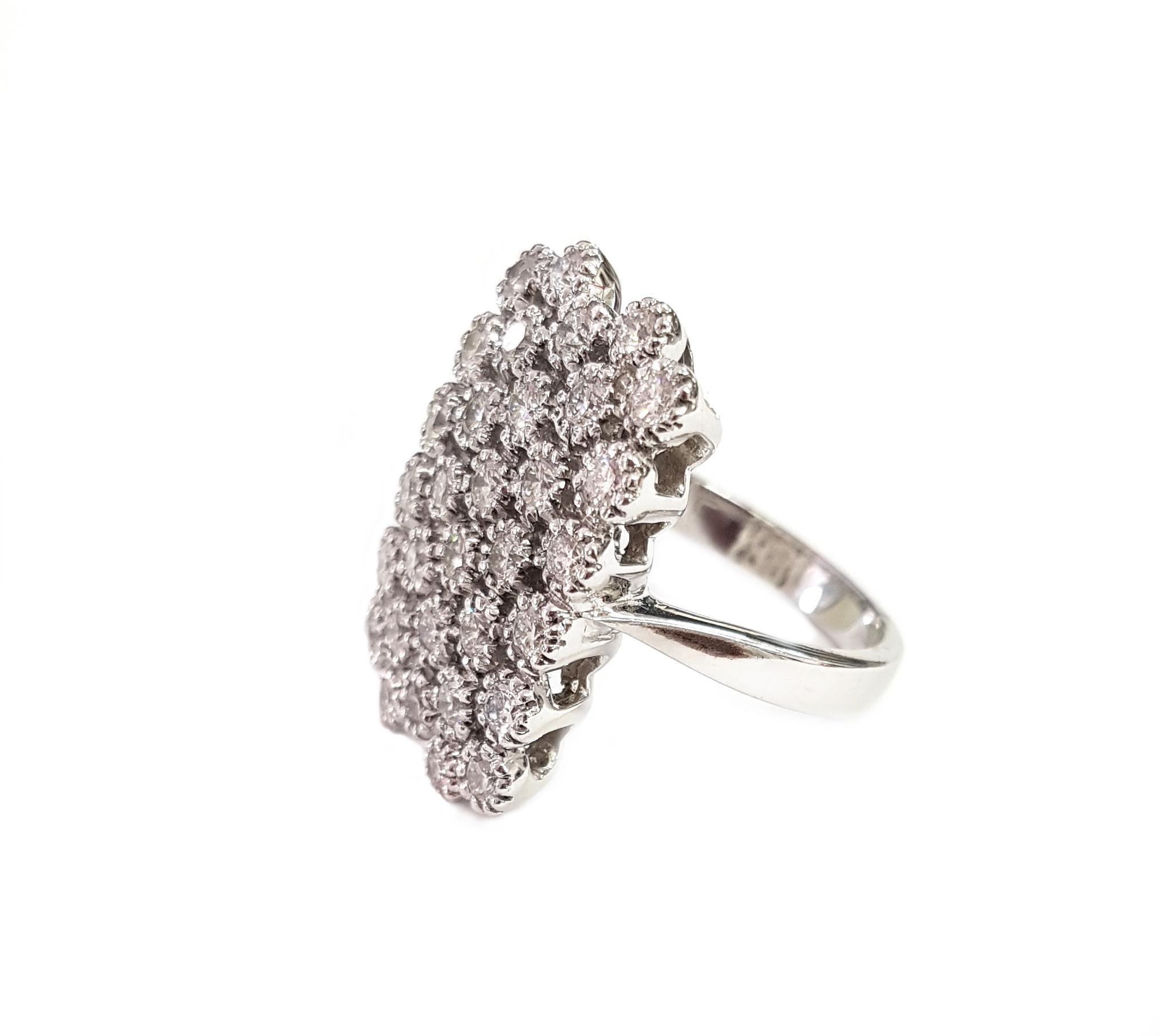 This 18-karat white gold and diamond cocktail ring extends beautifully down the finger.  

Thirty-two (32) round-cut diamonds totalling 1.38 carats are set in staggered rows and sit atop a simple white gold band. The ring is 2 centimetres long.