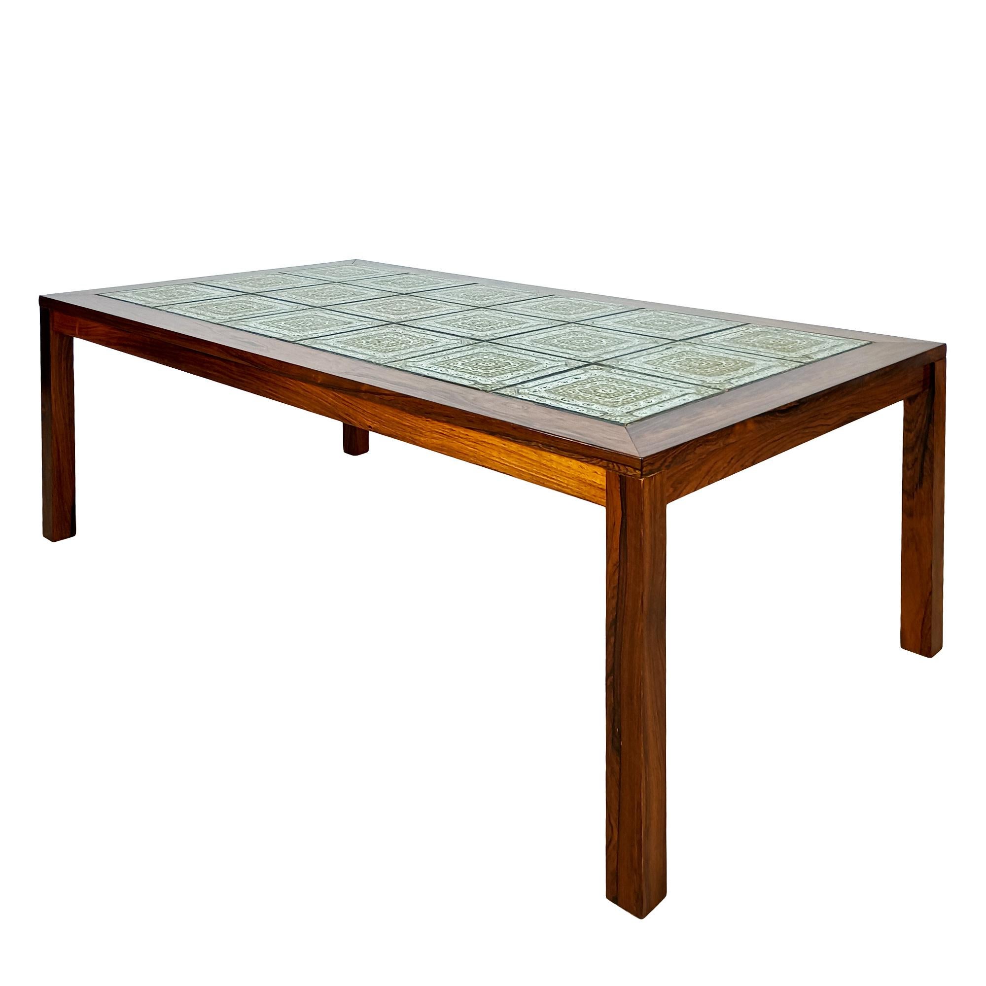 Rectangular coffee table with rosewood veneer and 4 removable legs, top with rosewood frame and 18 ceramic tiles with geometric decoration in off-white and olive tones. Satin shellac finish.

Made by Gangso.

Denmark, dated 10 may 1973.