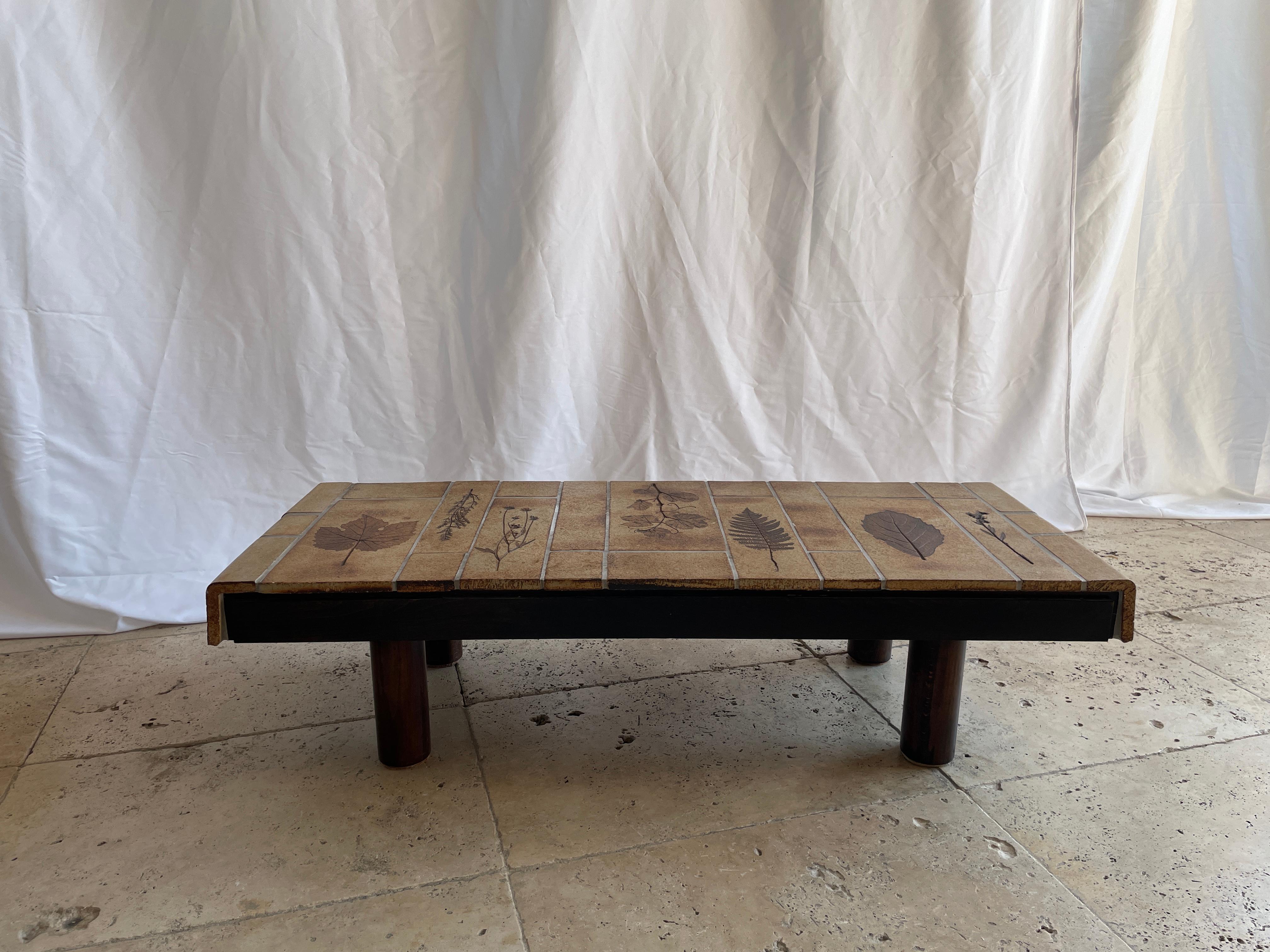 Coffee table from the garrigue series by the French designer Roger Capron for Vallauris, 1970s , good condition , the wood has no faults, the céramique is perfect. 

 Roger Capron was born in Vincennes, France on September 4, 1922. Interested in