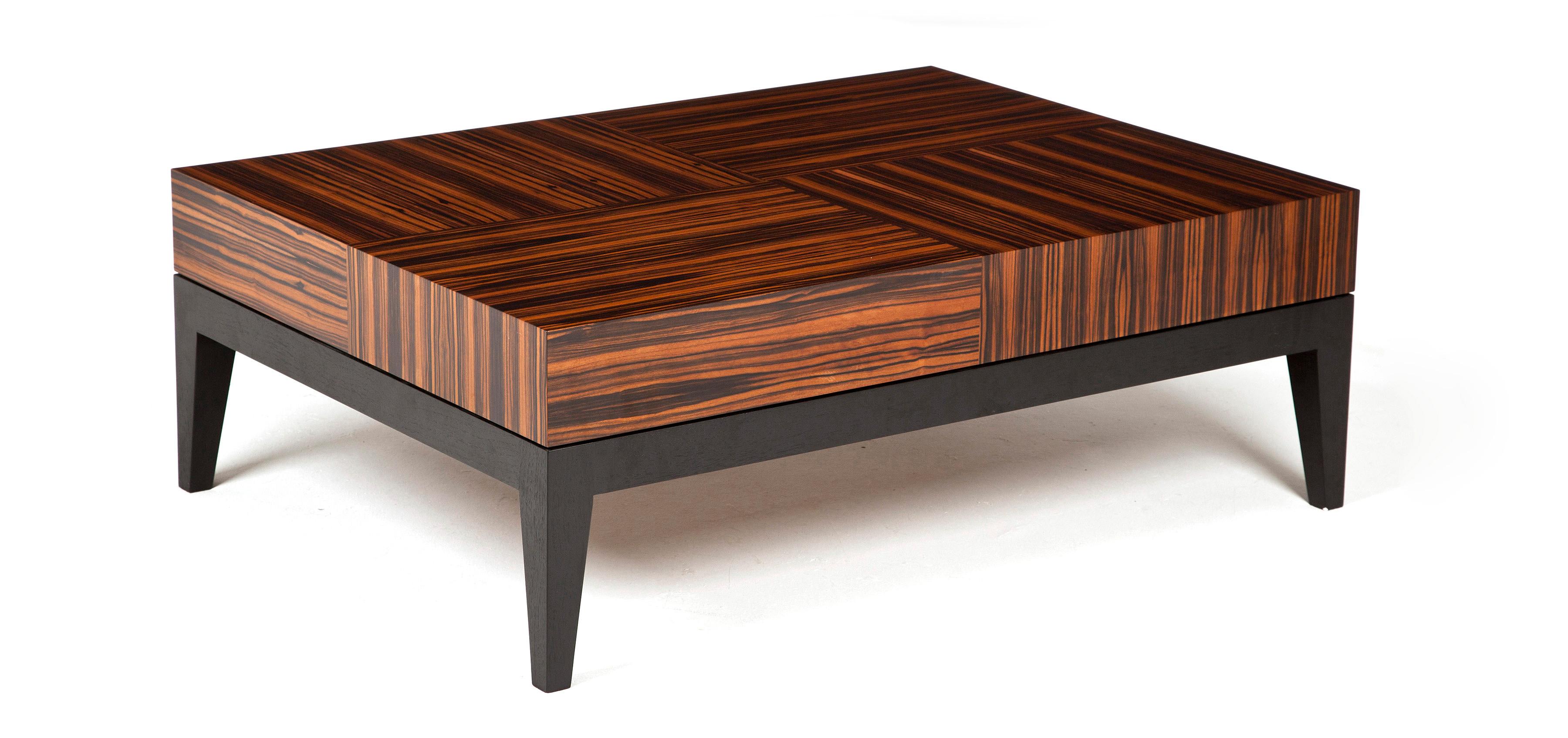 Statement rectangular coffee table with a bold and geometric Macassar ebony pattern and waterfall edge veneer detailing.

Stained walnut table base and legs.
Finished with a hard-wearing polyurethane lacquer.