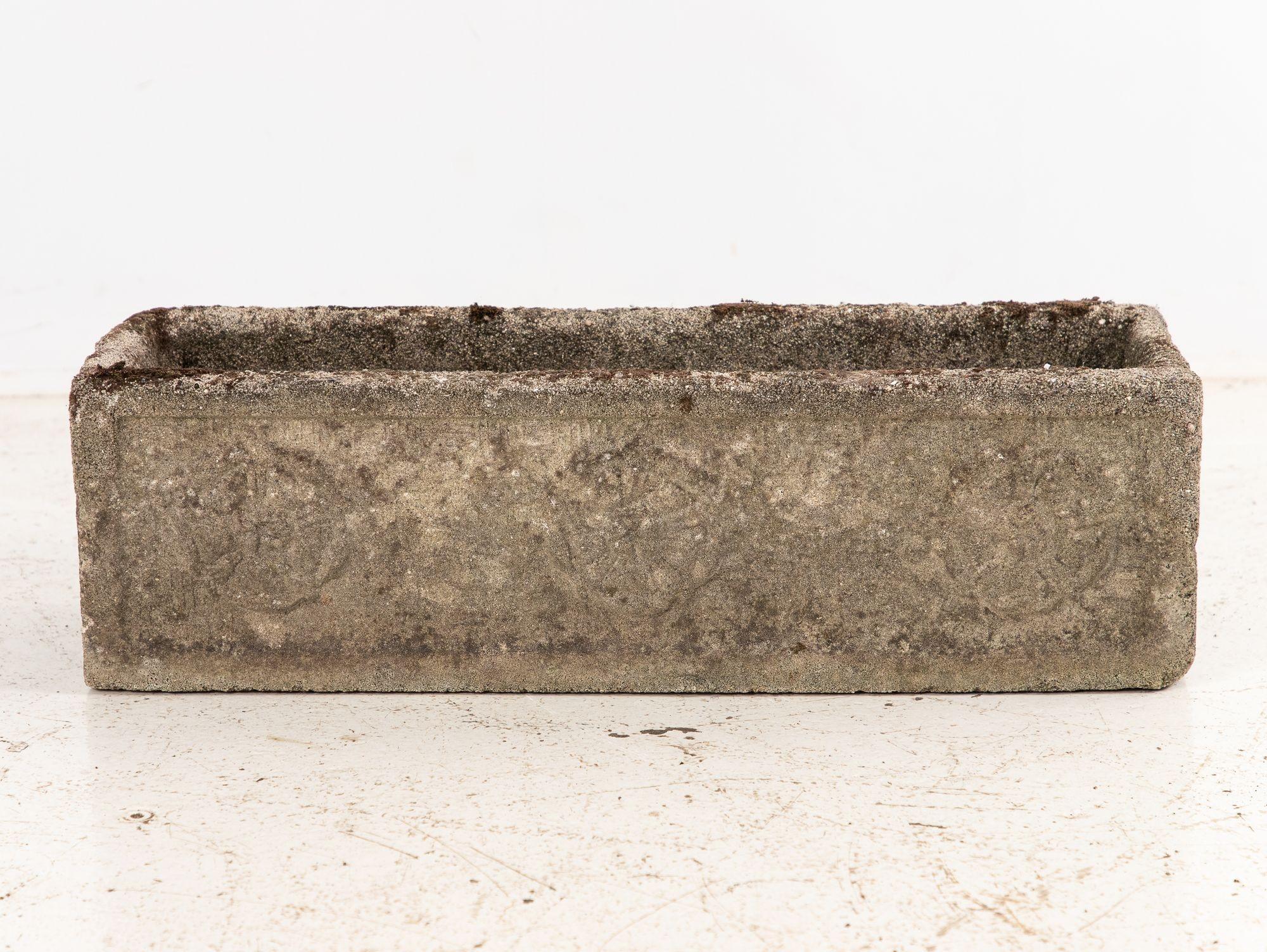 Rectangular concrete planter, England, 1960s. The front showcases a charming trio of Tudor Roses, with a single rose elegantly adorning each side. Its honest patina reflects decades of character, with wear and minor losses consistent with age and