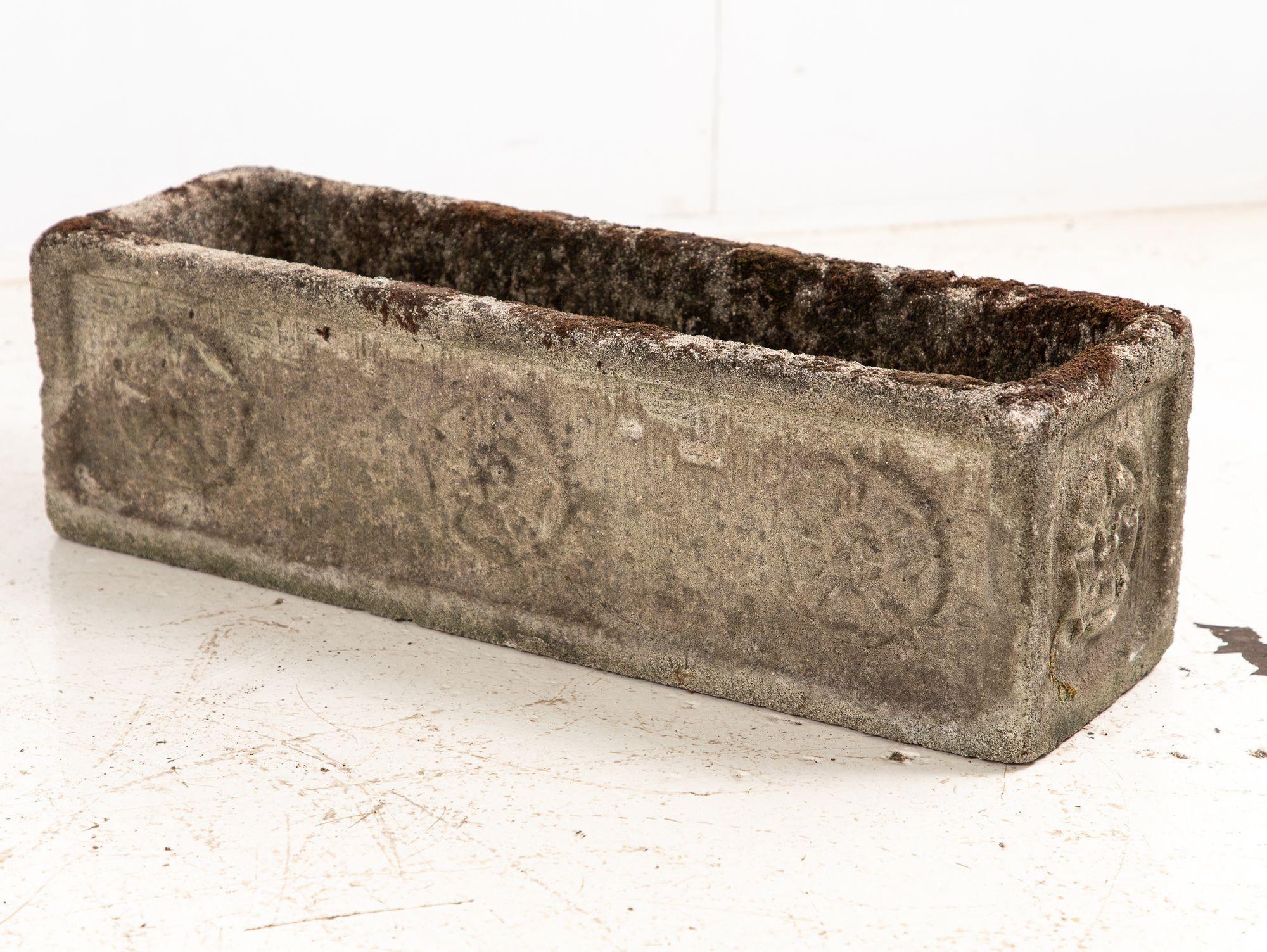 Rectangular concrete planter, England, 1960s. The front showcases a charming trio of Tudor Roses, with a single rose elegantly adorning each side. Its honest patina reflects decades of character, with wear and minor losses consistent with age and