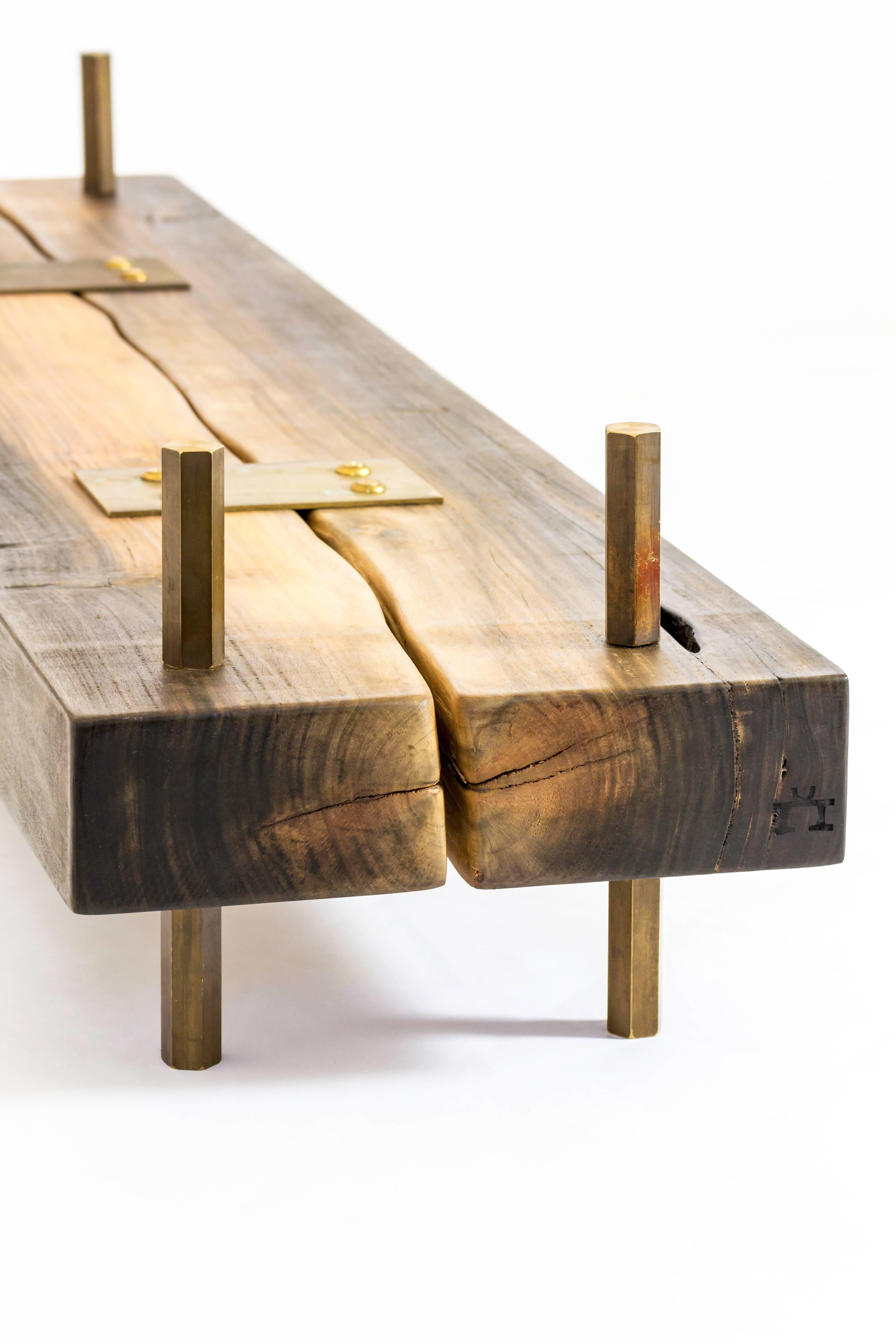Dos Hijos unites two beautiful rectangular lengths of rescued Mahoe wood in a contemporary connection, top in glass. The wood texture and tone in contrast with golden brass legs and details create a beautiful yet sophisticated piece. 

Rescued in