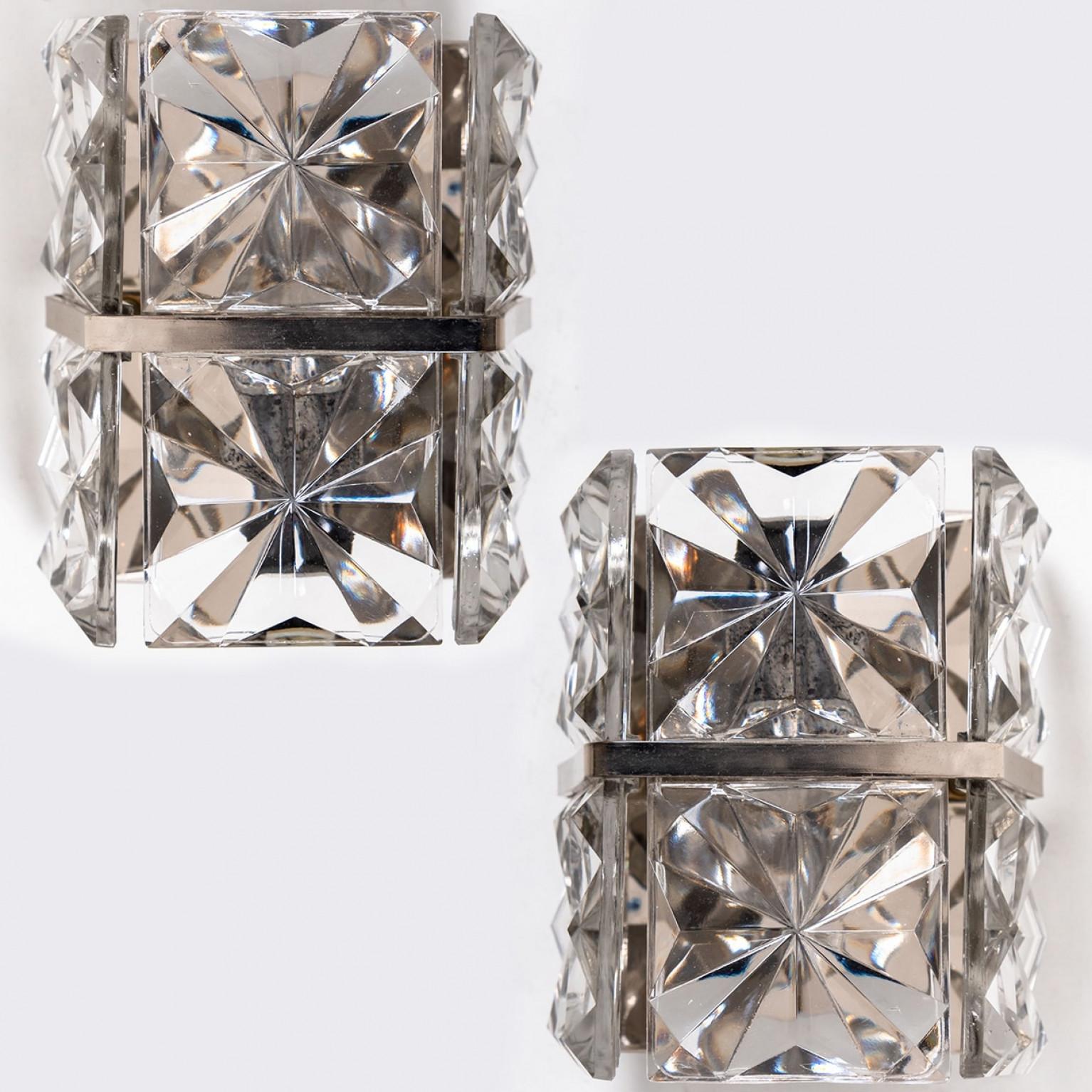 Luxurious of brass frame and thick diamond crystal sconces by the famed maker, Kinkeldey. A very elegant light fixtures, comfortable with all decor periods. The crystals are meticulously cut in such a way that radiate the light of the bulbs in