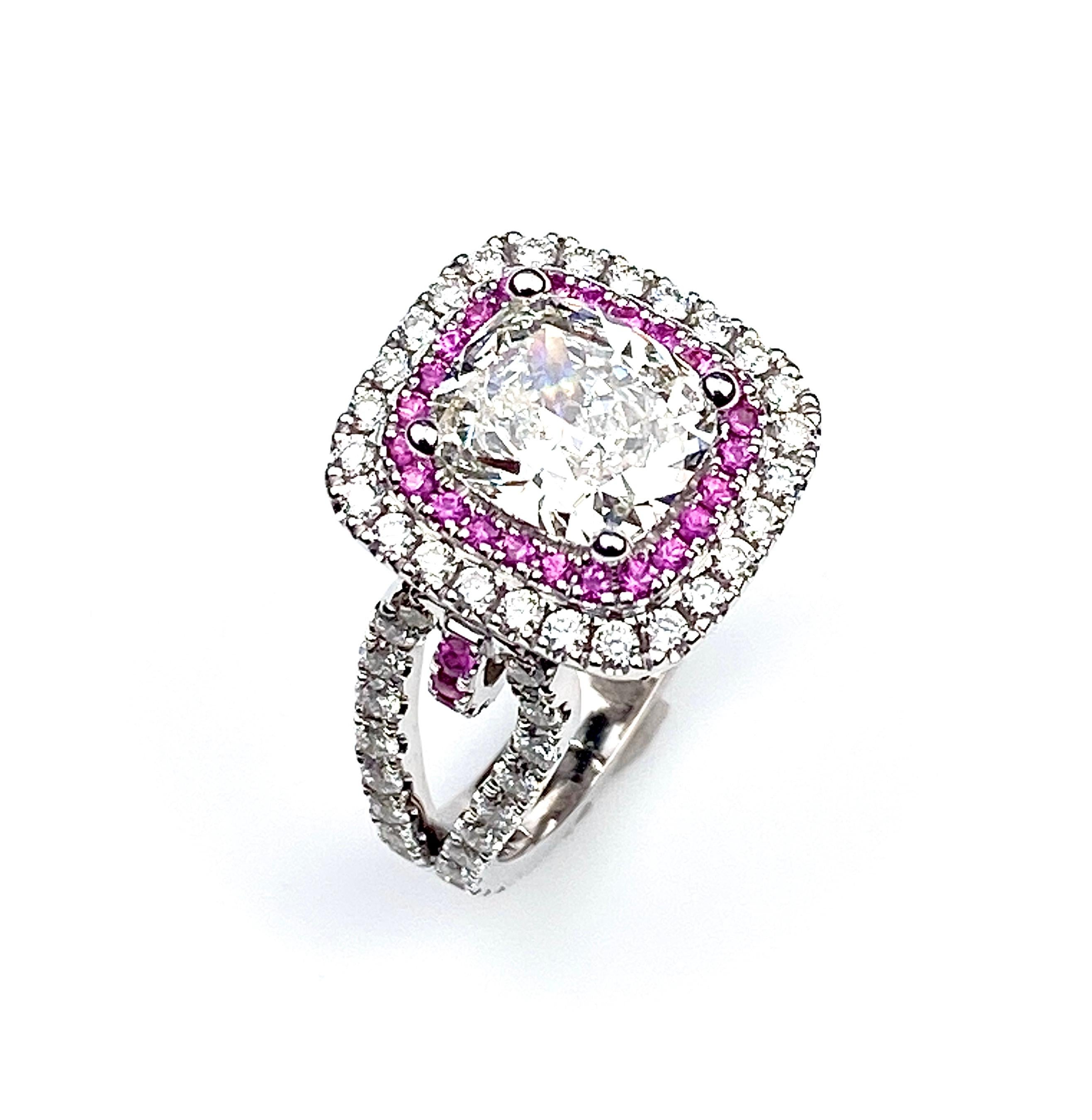 Double halo engagement ring with 1.70ct rectangular cushion cut center diamond H colour SI1 clarity, GIA #7272006151. Set with pink sapphire halo of 0.27ct total  and diamond-set outer halo, loop shank and petal pave' under-gallery, 1.27ct total.