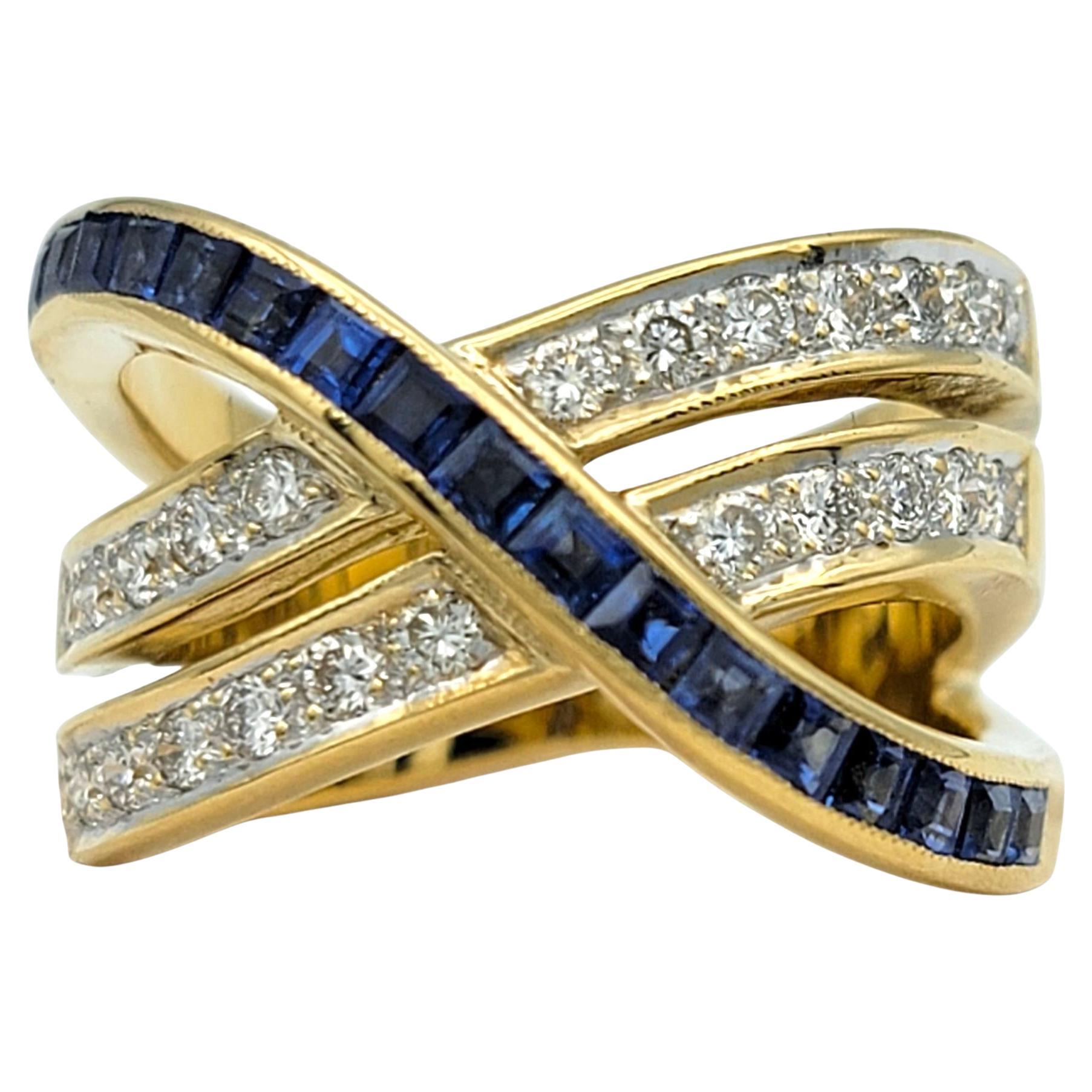 Ring Size: 6

This sophisticated sapphire and diamond ring features an elegant crossover design that blends modern lines with timeless sparkle. Two bands shimmer with round brilliant-cut diamonds, while the other glows with rectangular blue