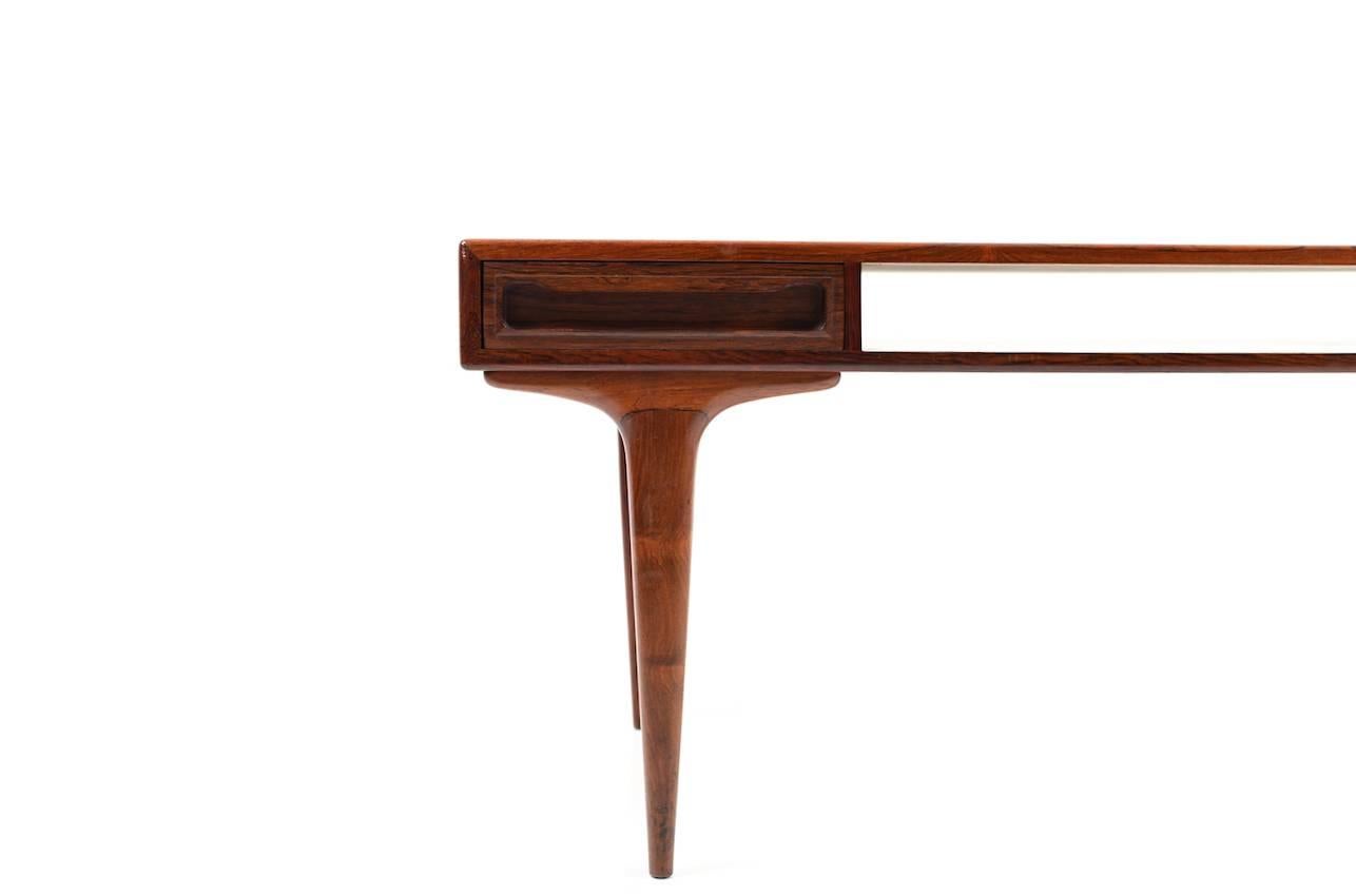 Rectangular Danish rosewood sofa table with two drawers. The drawers are double-sided. The table is centered with storage compartment. Denmark, early 1960s. In very good stand.