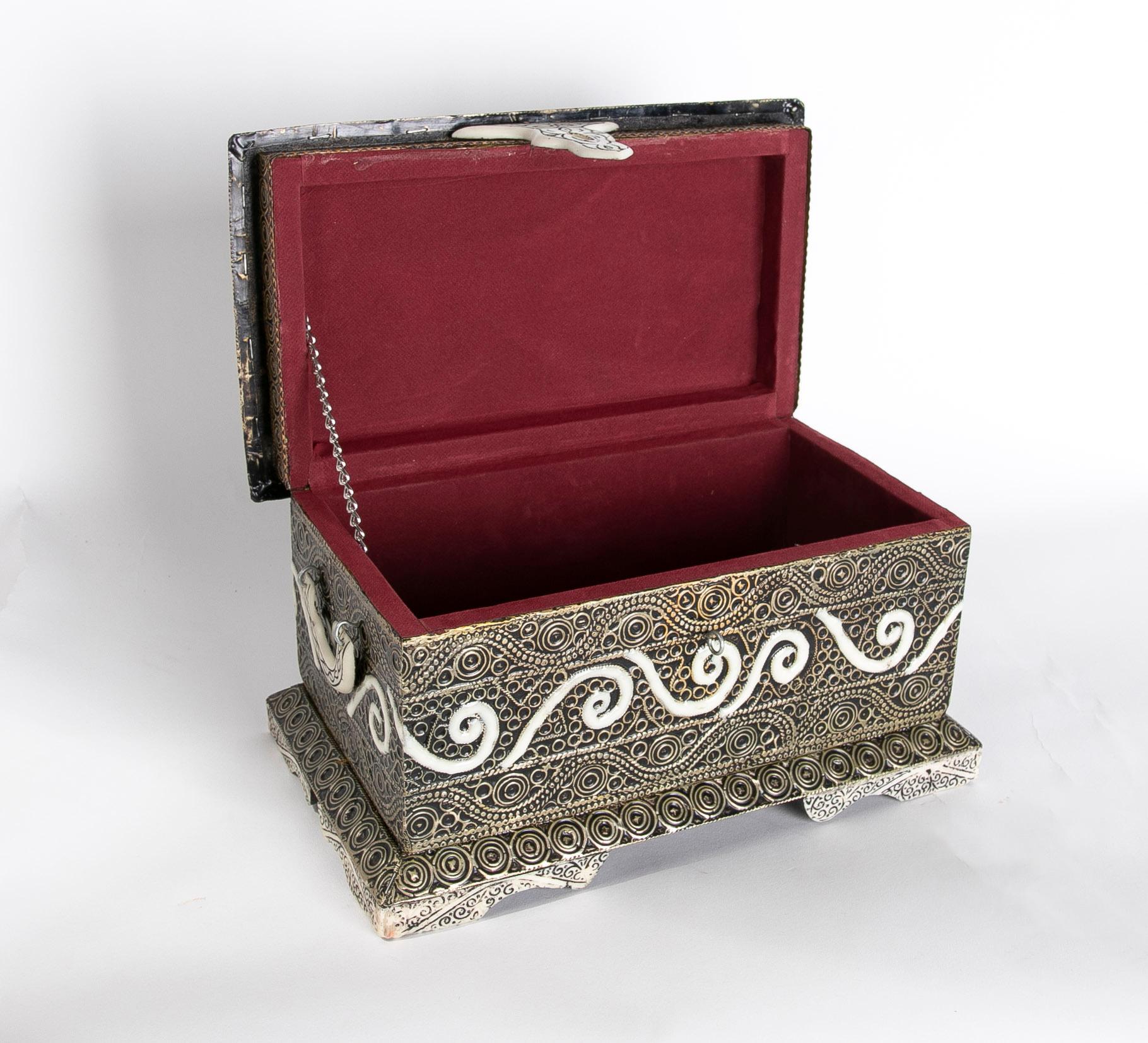 Rectangular decorative box with lid and circular motifs.