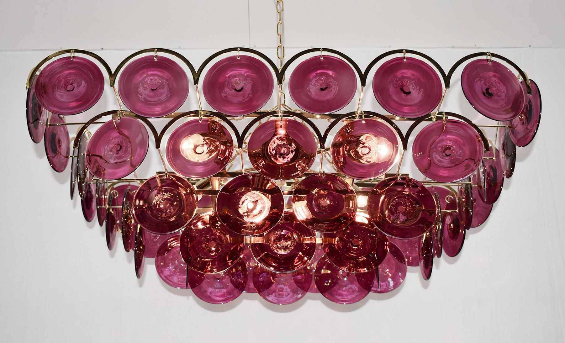 Italian chandelier with burgundy colored hand blown Murano glass discs mounted on 24 karat gold plated metal frame with decorative arch details, by Fabio Ltd / Made in Italy 
6 lights / E26 or E27 type / max 60W each 
Measures: Length 37.5 inches,
