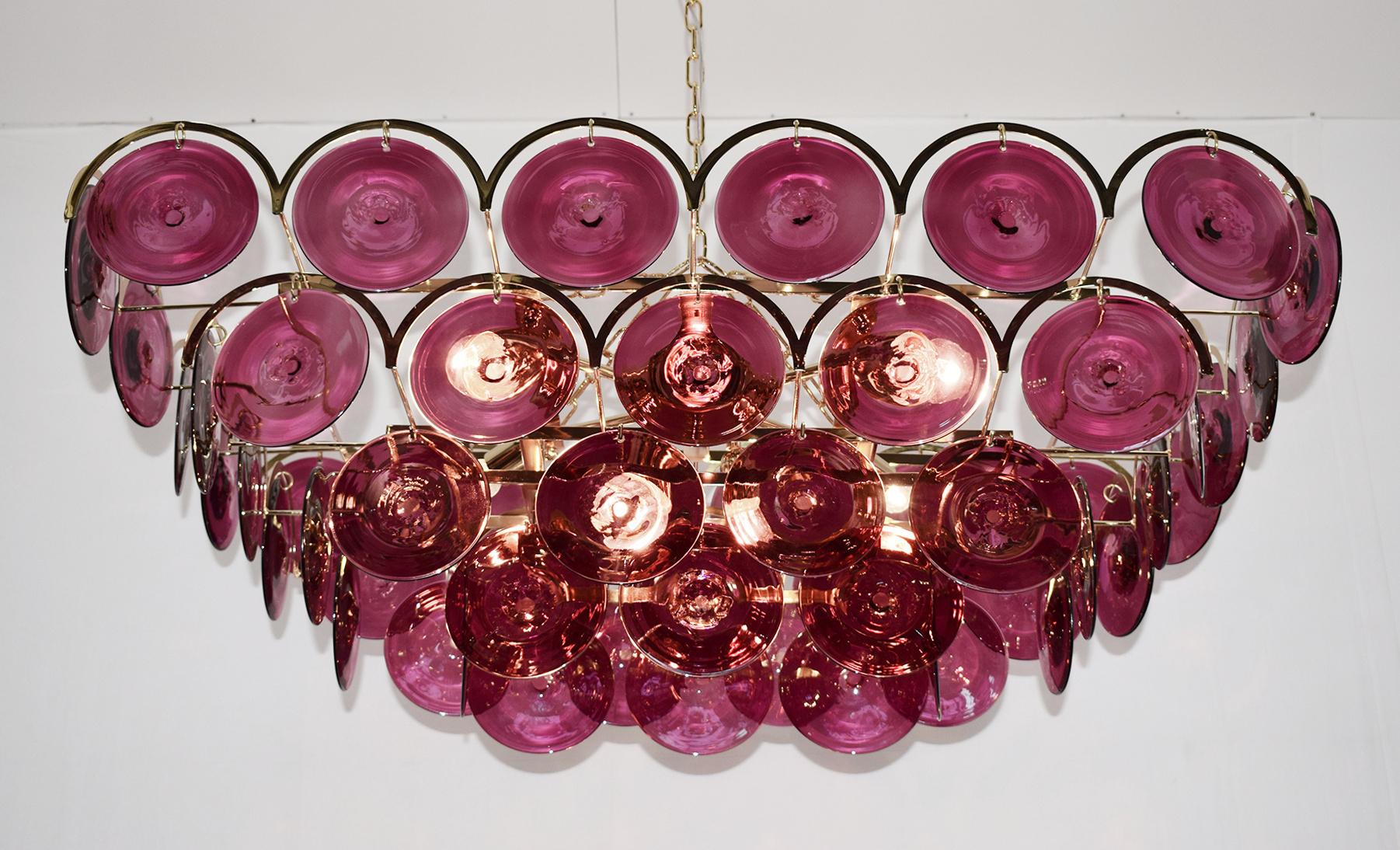 Italian chandelier with burgundy colored hand blown Murano glass discs mounted on 24 karat gold plated metal frame with decorative arch details, by Fabio Ltd / Made in Italy
6 lights / E26 or E27 type / max 60W each
Measures: Length 37.5 inches,