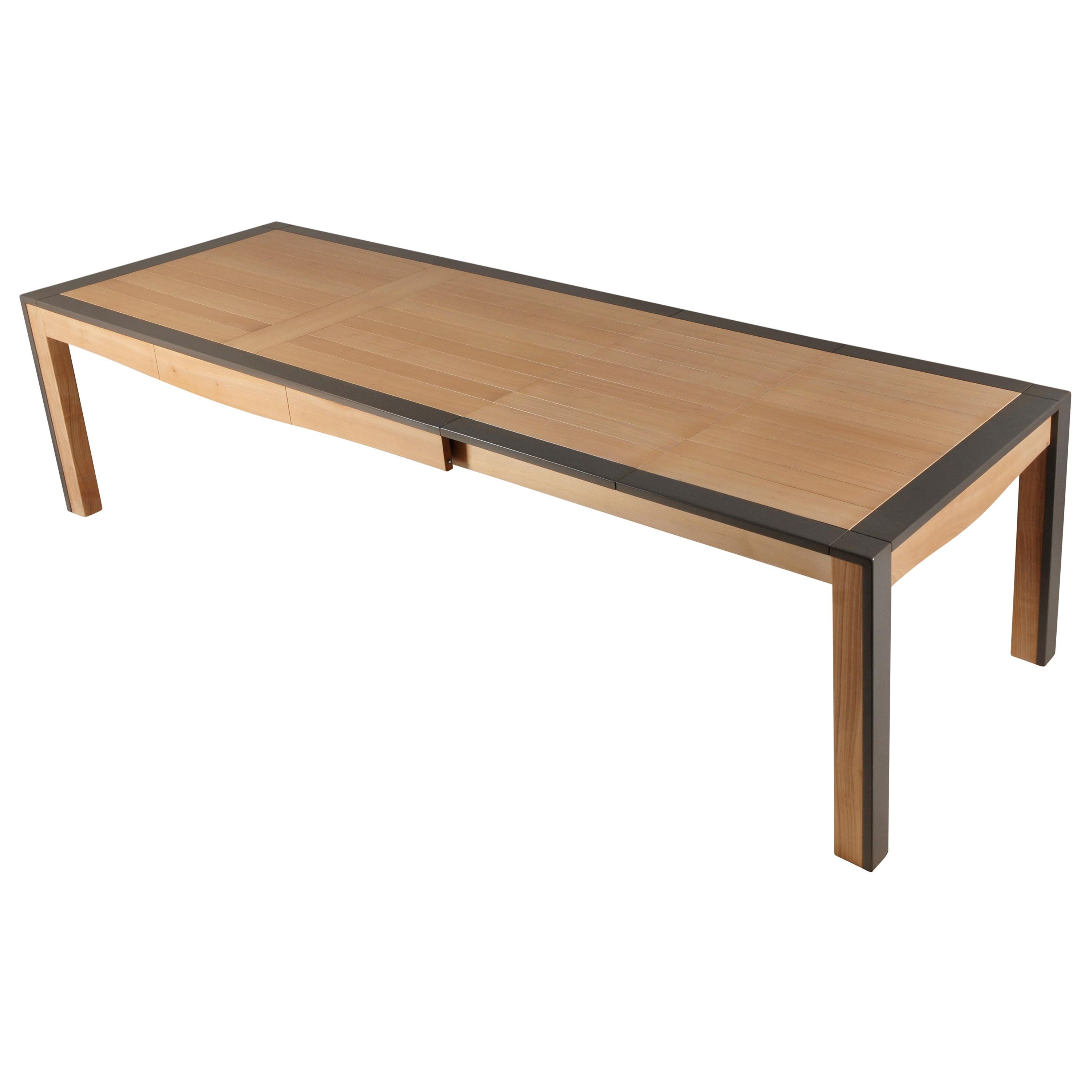 This rectangular dining table is made of Cherry wood and designed by Christophe Lecomte a French Designer. Christophe likes to combine right contemporary lines with smooths curves under the table top.


The paneling top opens at the foot end for