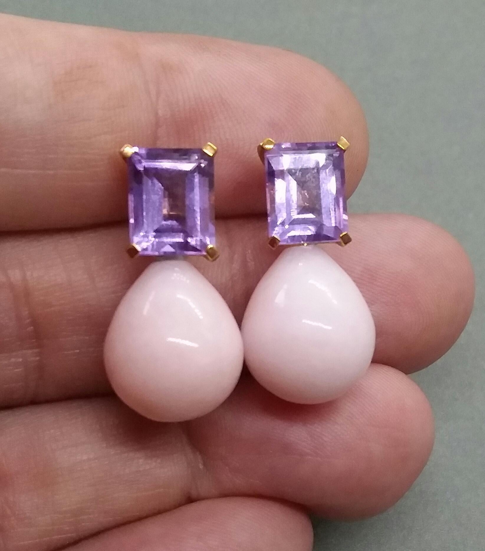 These simple but elegant earrings have 2 faceted rectangular shape Natural Amethysts set in yellow gold at the top to which are suspended 2 Pink Opal Plain Round Drops

In 1978 our workshop started in Italy to make simple-chic Art Deco style