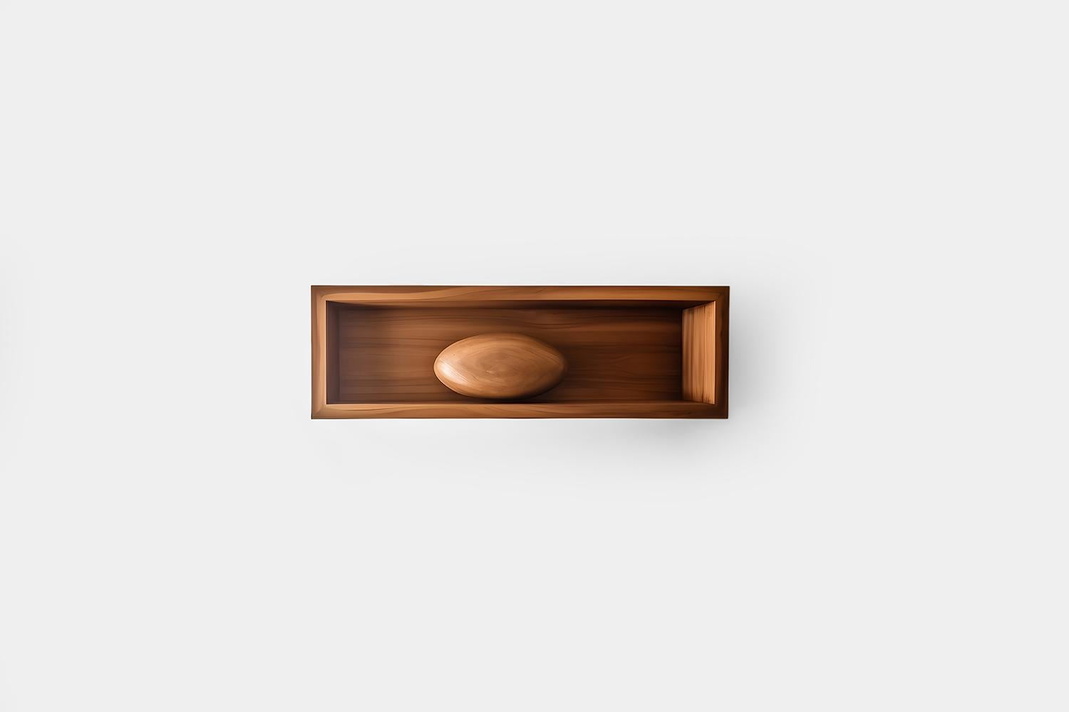 Rectangular Floating Shelf with Close Back and One Large Sculptural Wooden Pebble Accent, Sereno by Joel Escalona

—

What happens when the practical becomes art?
What happens when ornamentation gains significance?

Those were the questions Joel