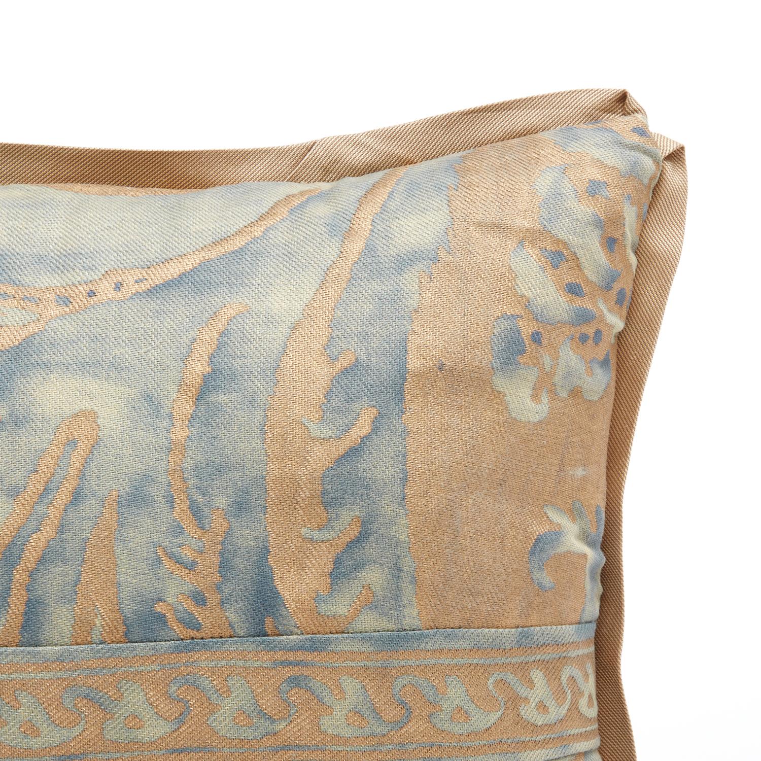 A rectangular Fortuny fabric cushion in the Glicine pattern, with self pattern gallon border detail and bias gold silk edge trim. Gold silk back. 

50 down/50 feather insert. Newly made using vintage Fortuny fabric. This cushion is one of a kind.
