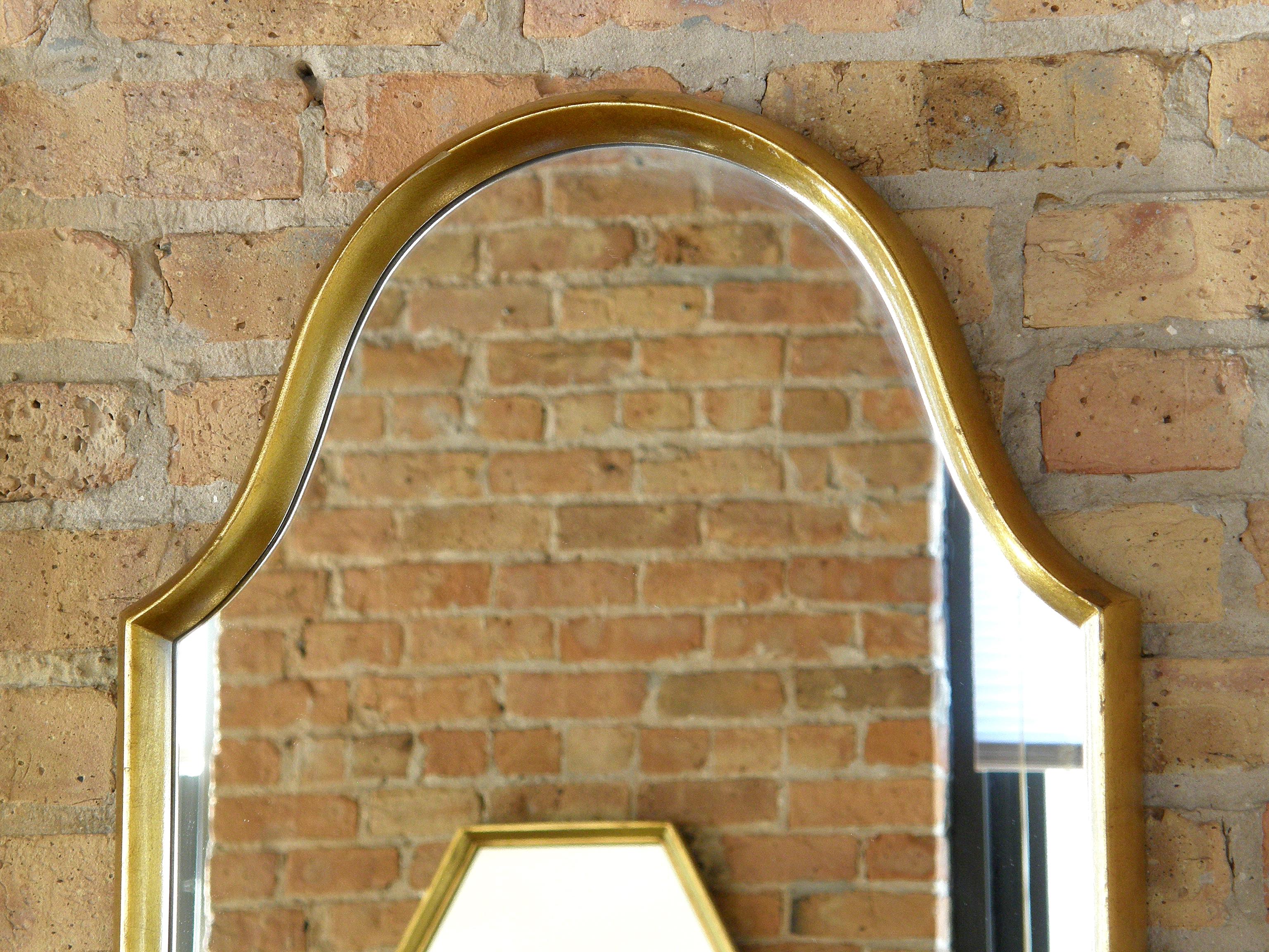 The arched top provides a pleasing variation to the standard rectangular form of this giltwood wall mirror. The deep frame gives a subtle shadowbox effect.

  