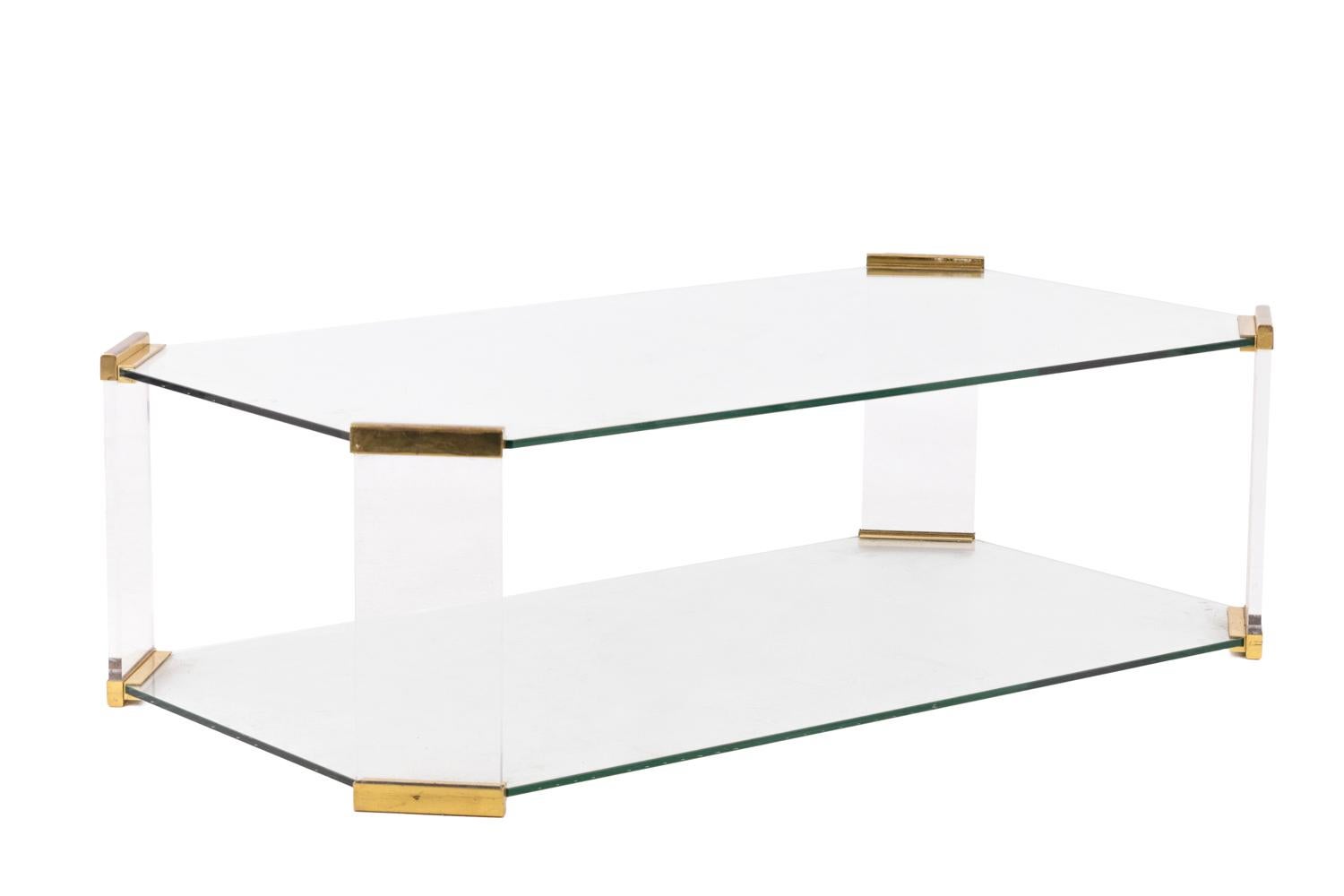 Rectangular glass coffee table with canted corners and stretcher glass tray. Gilt bronze joints on corners.
Work from the 1970s.