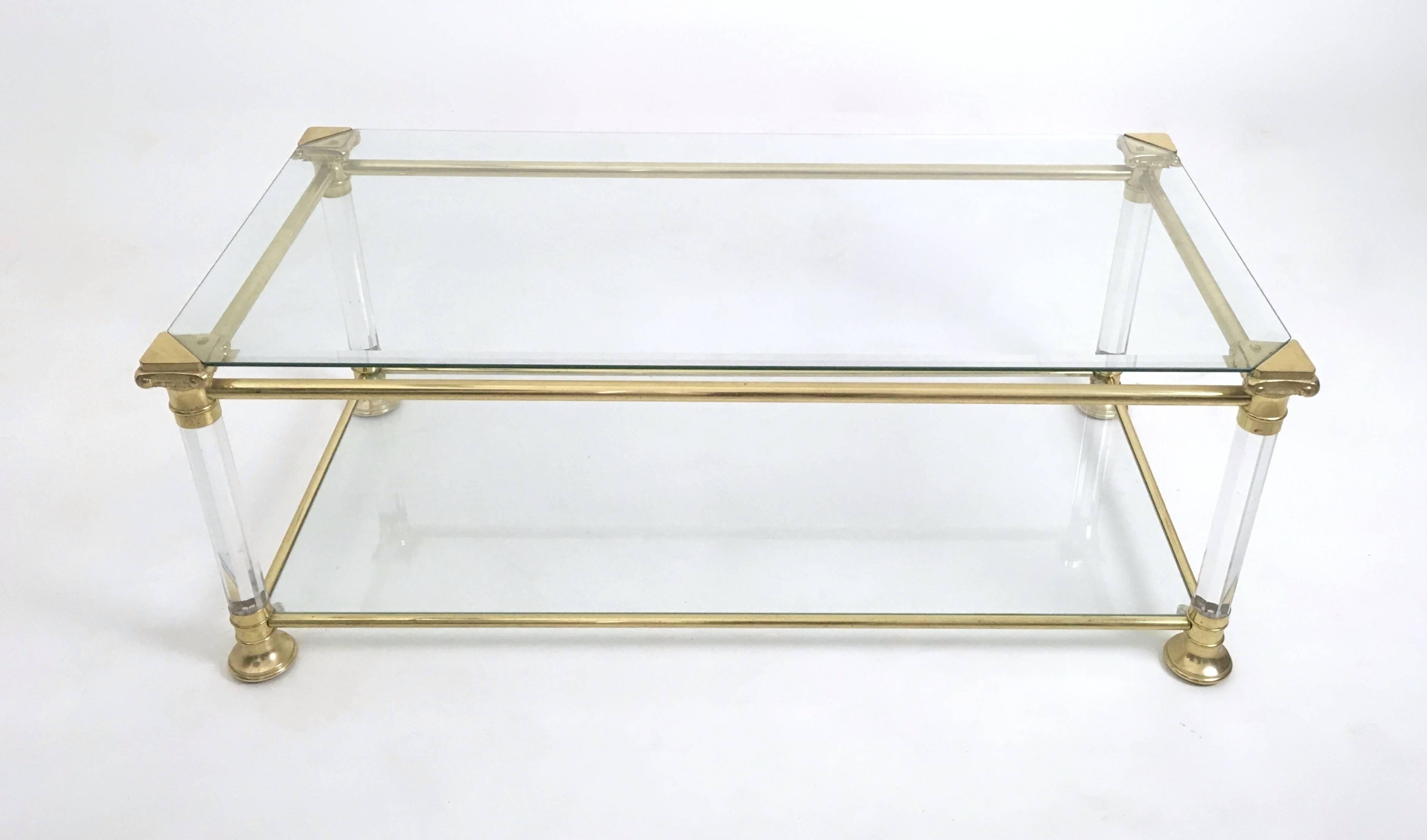 Made in Italy, 1980s. 
This coffee table features a plexiglass and brass frame with two beveled glass shelves. 
It is a vintage piece, therefore it might show slight traces of use, but it can be considered as in very good original condition and