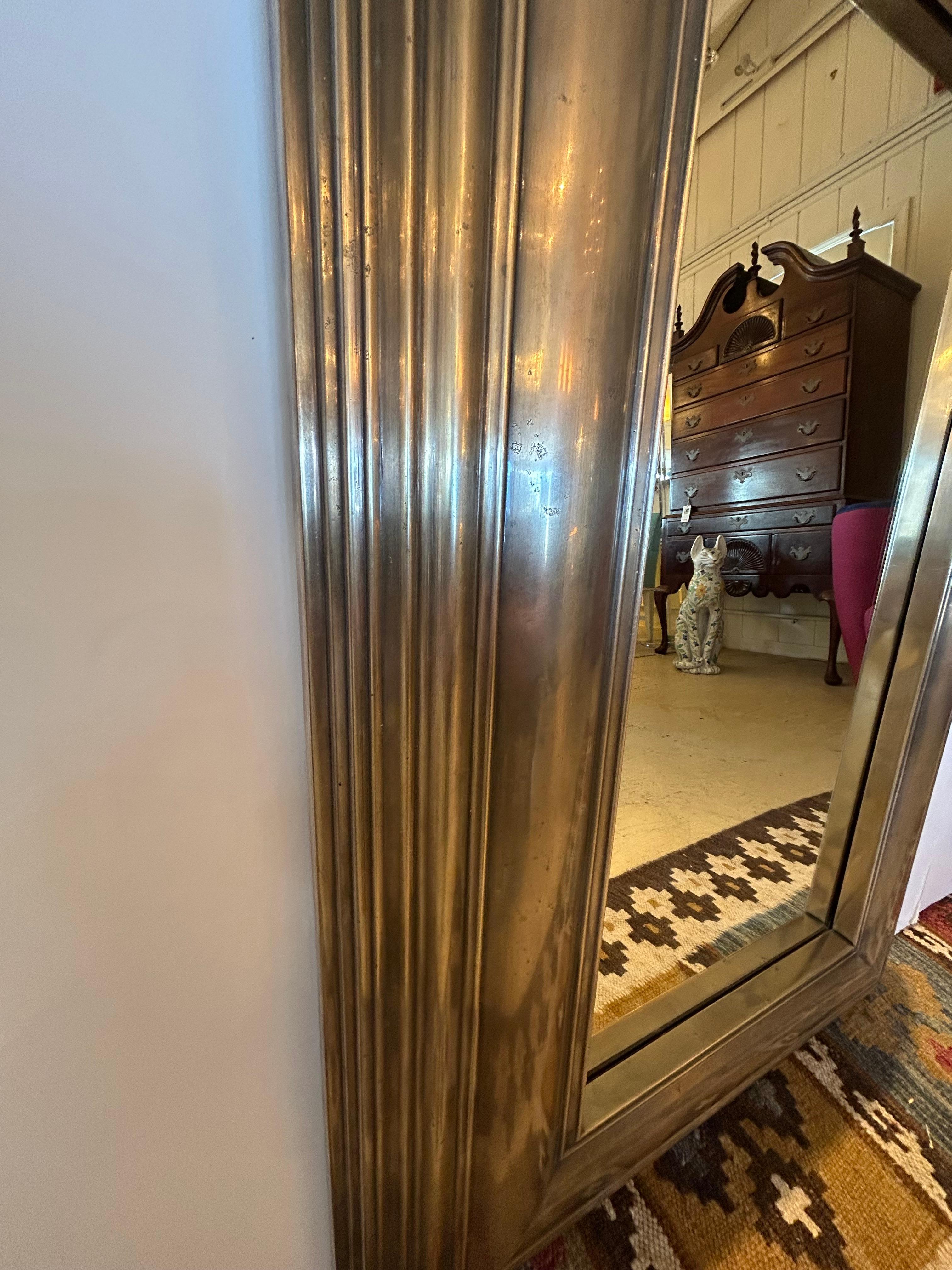 Masculine antiqued metal mirror having chunky graduated frame with pewter silverplate finish and bevelled mirror.  Mirror itself is 13.5 w x 27.5 h
Can be hung either horizontal or vertical.