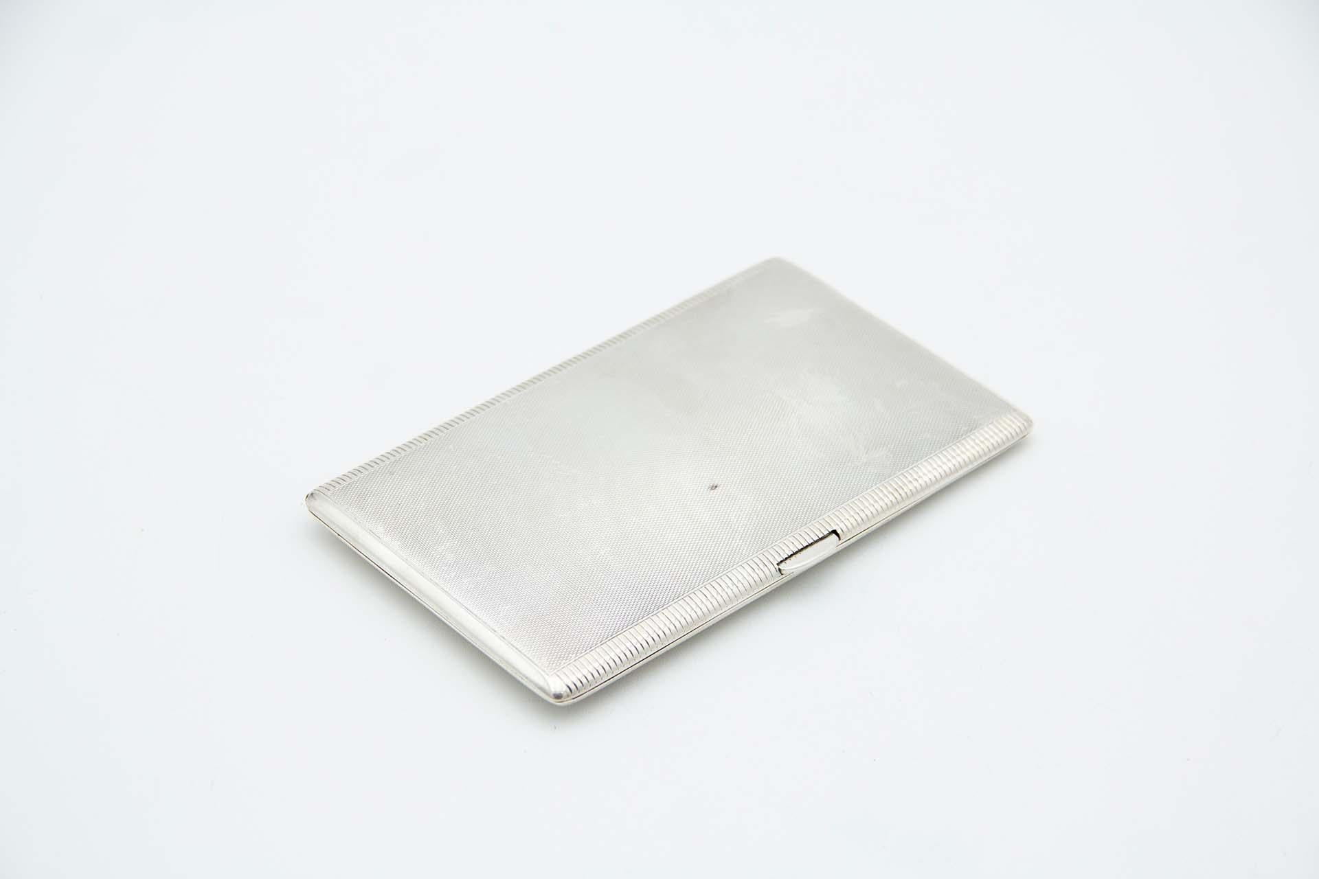 Description: Rectangular guilloche silver cigarette case with micro-relief patterns and gold interior. Metal: Silver. Origin: English. Brand: Birmingham. Weight: 200.10 grams. Dimensions: 14.4cmx1.3cm. Content: 925/1000. Assay Mark: Yes, 1997.