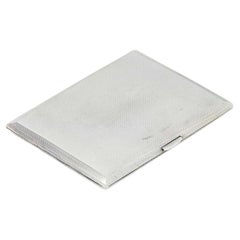 Rectangular guilloche silver cigarette case with spring lid and gold interior