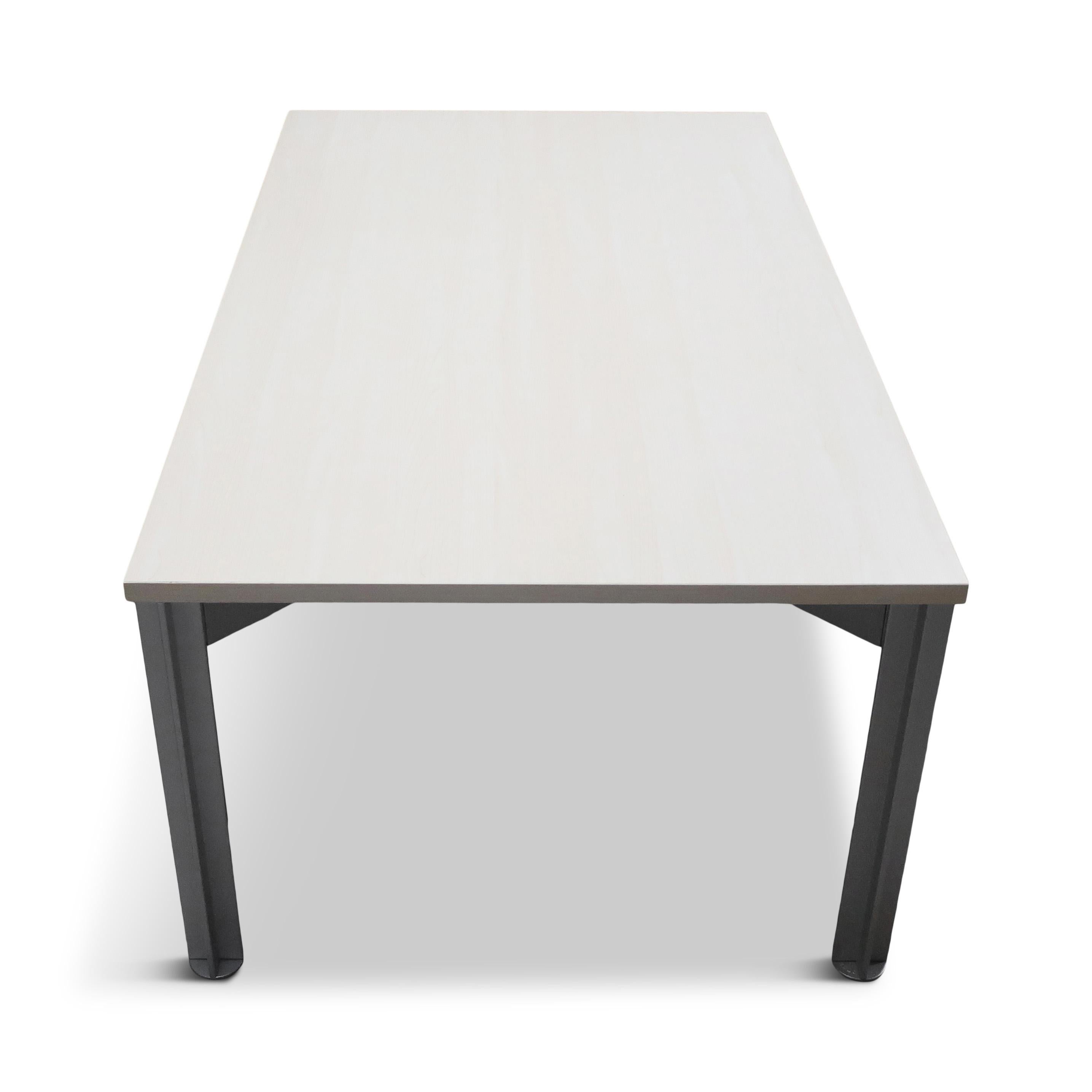 Designed by Claire Bataille and Paul Ibens in 1994 for Bulo, the Belgian furniture maker, this simple rectangular table from the H20 line has an off-white top on 4 cross-shaped legs. The table can function as work, meeting or dining table and fits