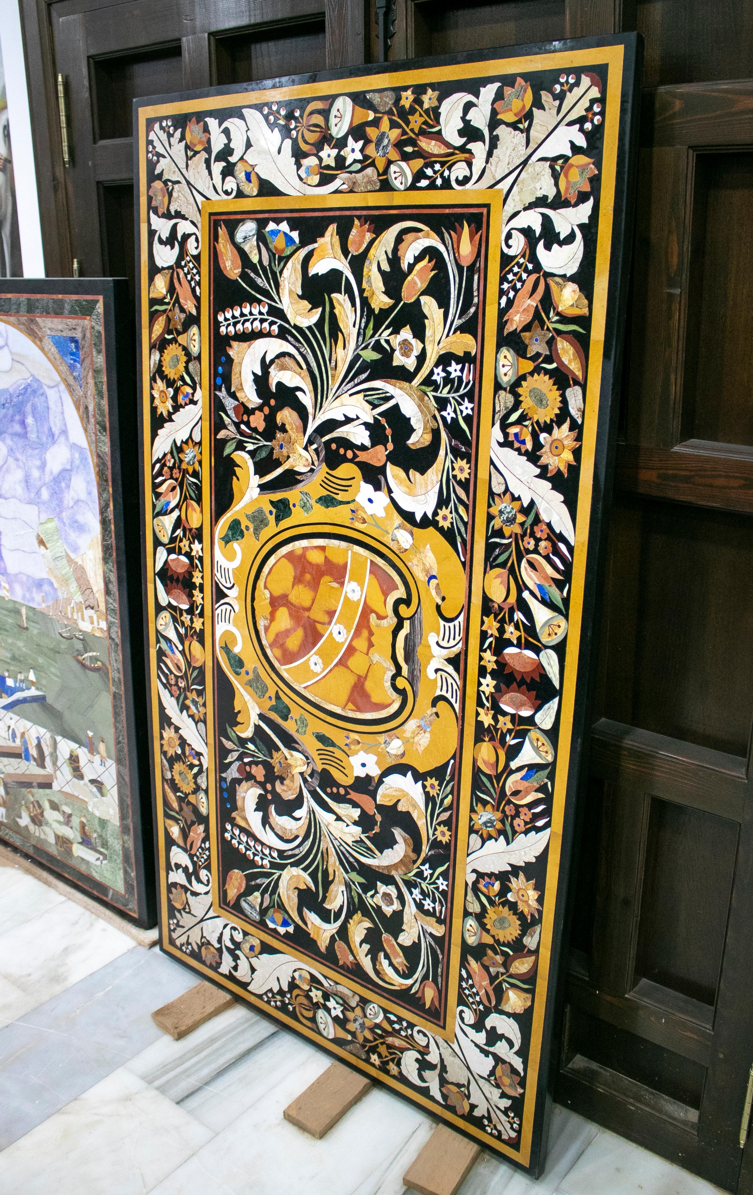 Rectangular Italian Florentine Pietra Dura Stone black marble table top with a framed coat of arms mosaic inlay hand crafted using blue lapis lazuli and an assortment of semiprecious stones and marbles, predominantly ochre.