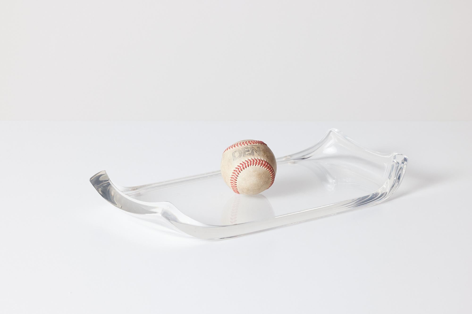 Rectangular Lucite tray with the two longer sides curving upwards.

Dimensions: 16