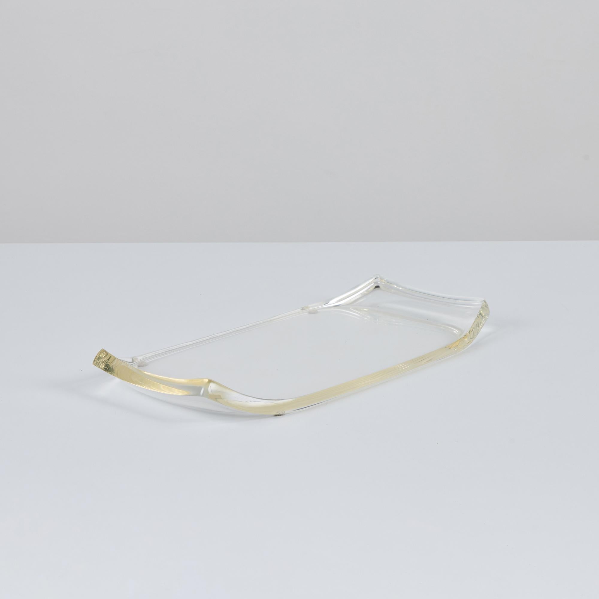 Lucite tray by Ritts Co., c.1970s, USA. The tray features a  rectangular shape with the two longer sides curving upwards.

Dimensions
16