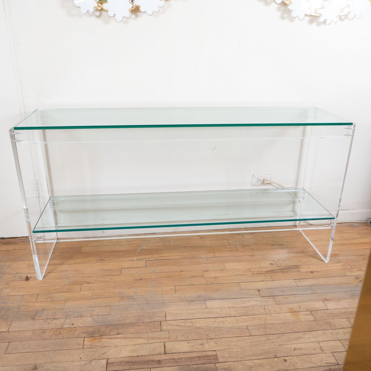 Rectangular Lucite two tier console with glass shelves.