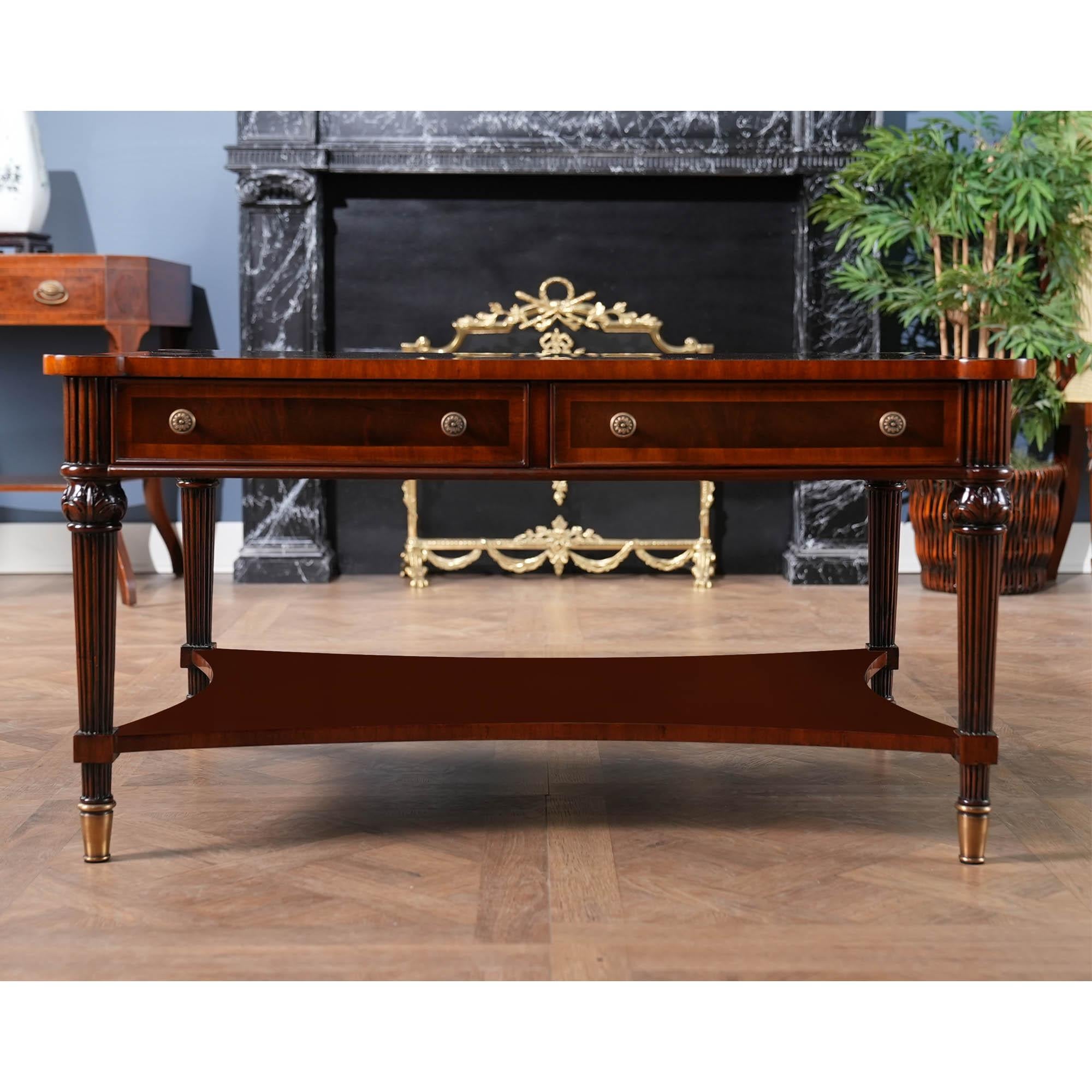 A Rectangular Mahogany Coffee Table from Niagara Furniture with all of the bells and whistles including four drawers, reeded legs, solid brass capped feet and cookie shaped, rounded corners. Great quality construction and attention to detail make