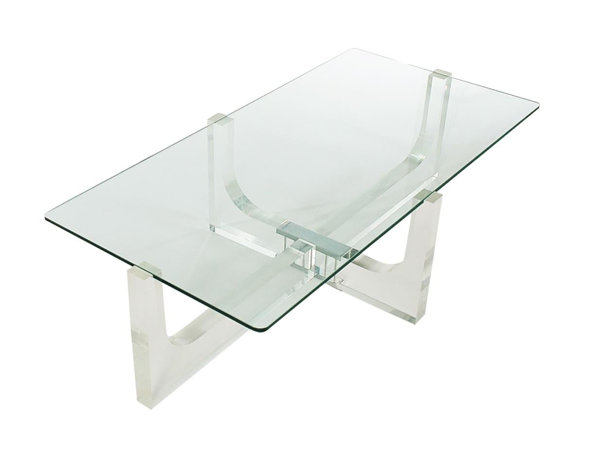 A clean modern look straight out of the early 1970s. This table features very thick Lucite construction, chrome detailing, and a heavy rectangular glass top.