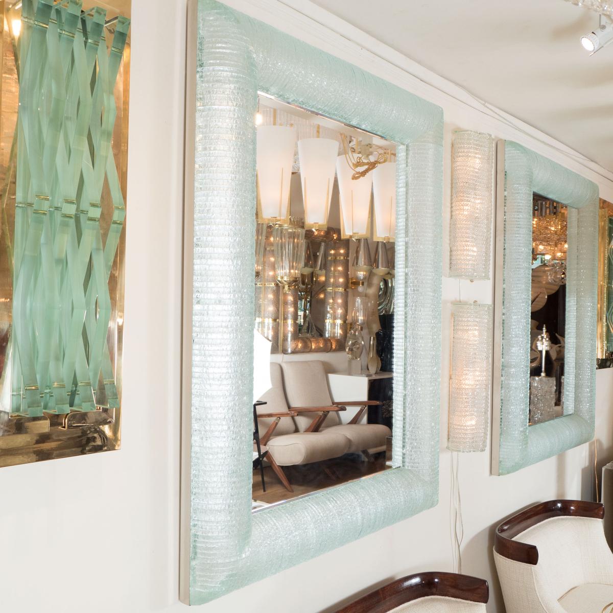 Rectangular mirror featuring curved and layered glass surround designed by John Salibello.