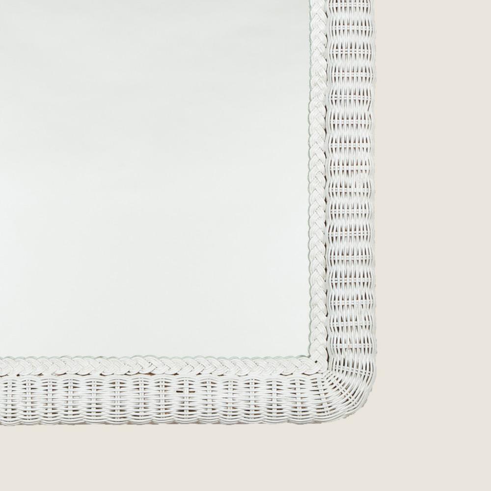 A rectangular mirror with an arched white-painted wicker frame, 20th century.
