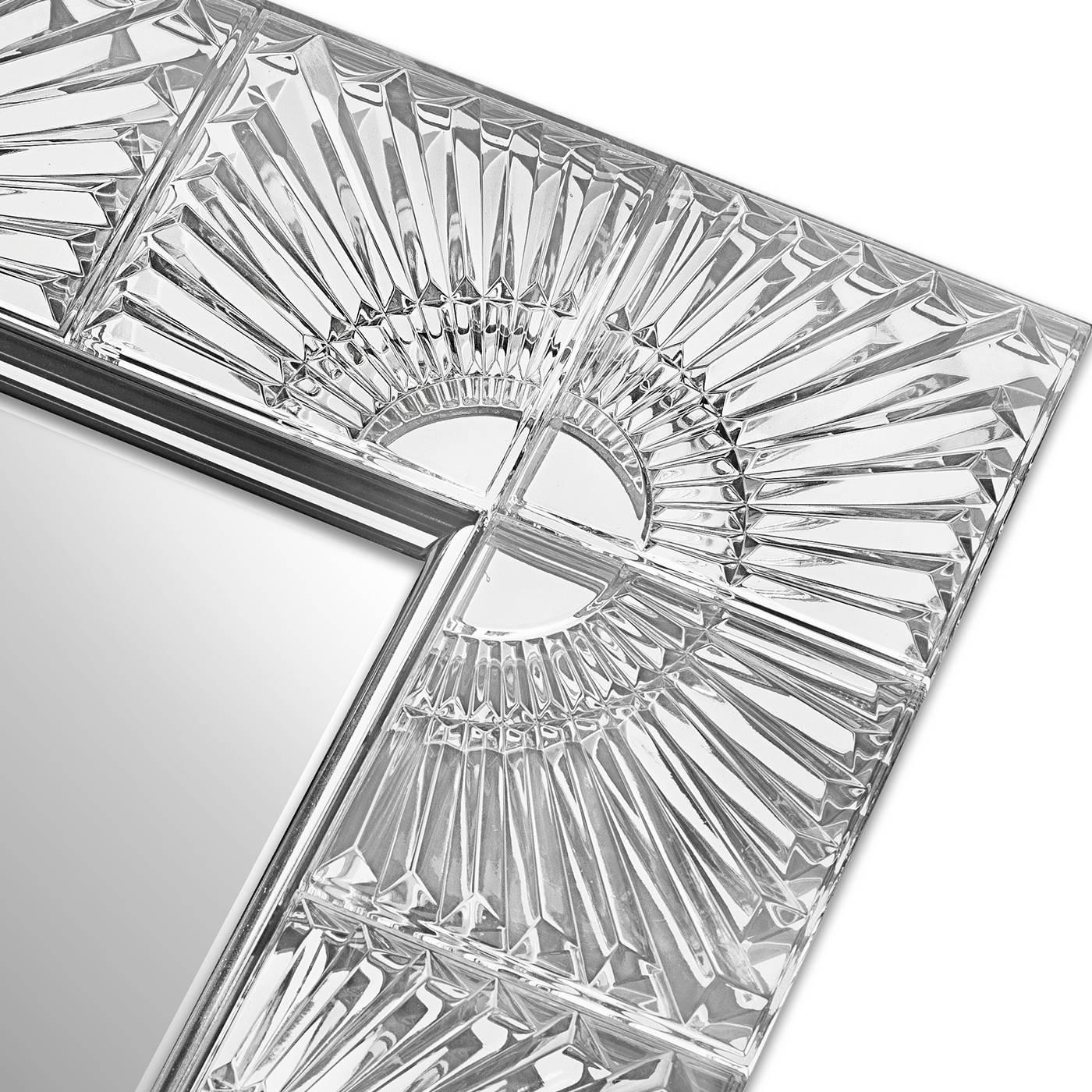 The ethereal elegance of crystal give this mirror a mesmerizing allure and makes it a timeless piece to adorn both a Classic and a modern home. The rectangular frame has a stainless steel structure that was entirely covered in 24% lead-crystal with