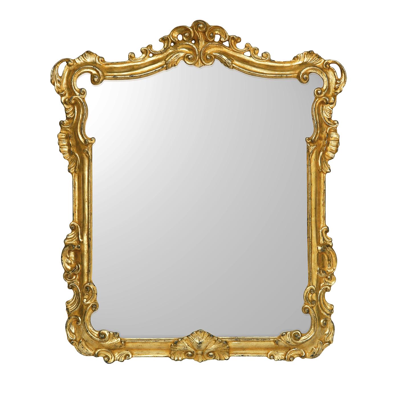 This superb mirror features a rectangular frame made of wood that was carved by hand and adorned throughout with gold leaf with a magnificent aged patina that lends it an antique allure. Inspired by the sinuous decorations found in 17th and 18th
