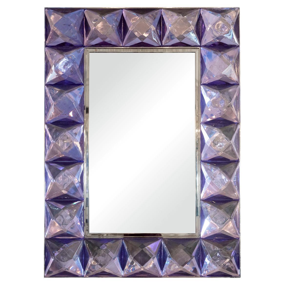 Rectangular mirror with lavender glass jewel surround.