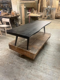 Rectangular modern coffee table with rounded corners and splayed tapered legs