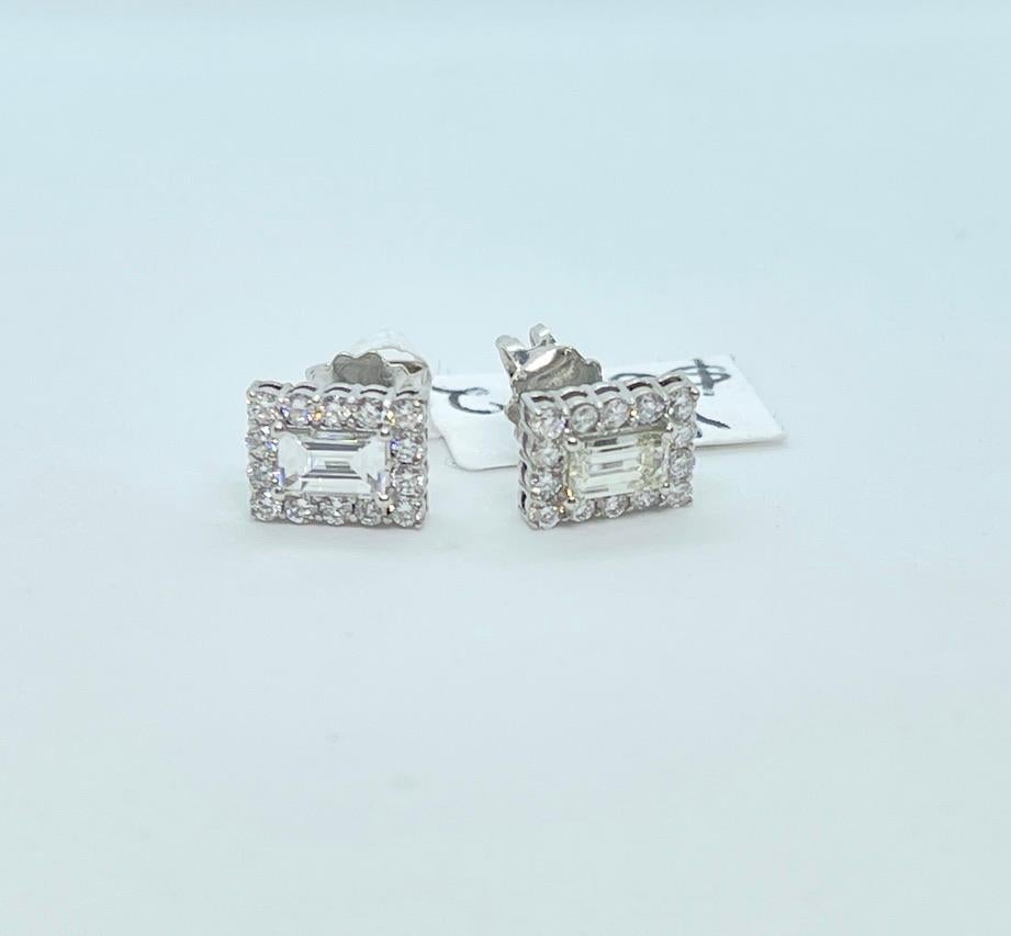 These beautiful earrings feature clean, white Natural Diamonds.
They are rectangular in shape and set in 18ct White Gold.
The centre Diamonds are Baguette cut and together, weigh approximately .57cts.  They are excellent quality and graded clarity