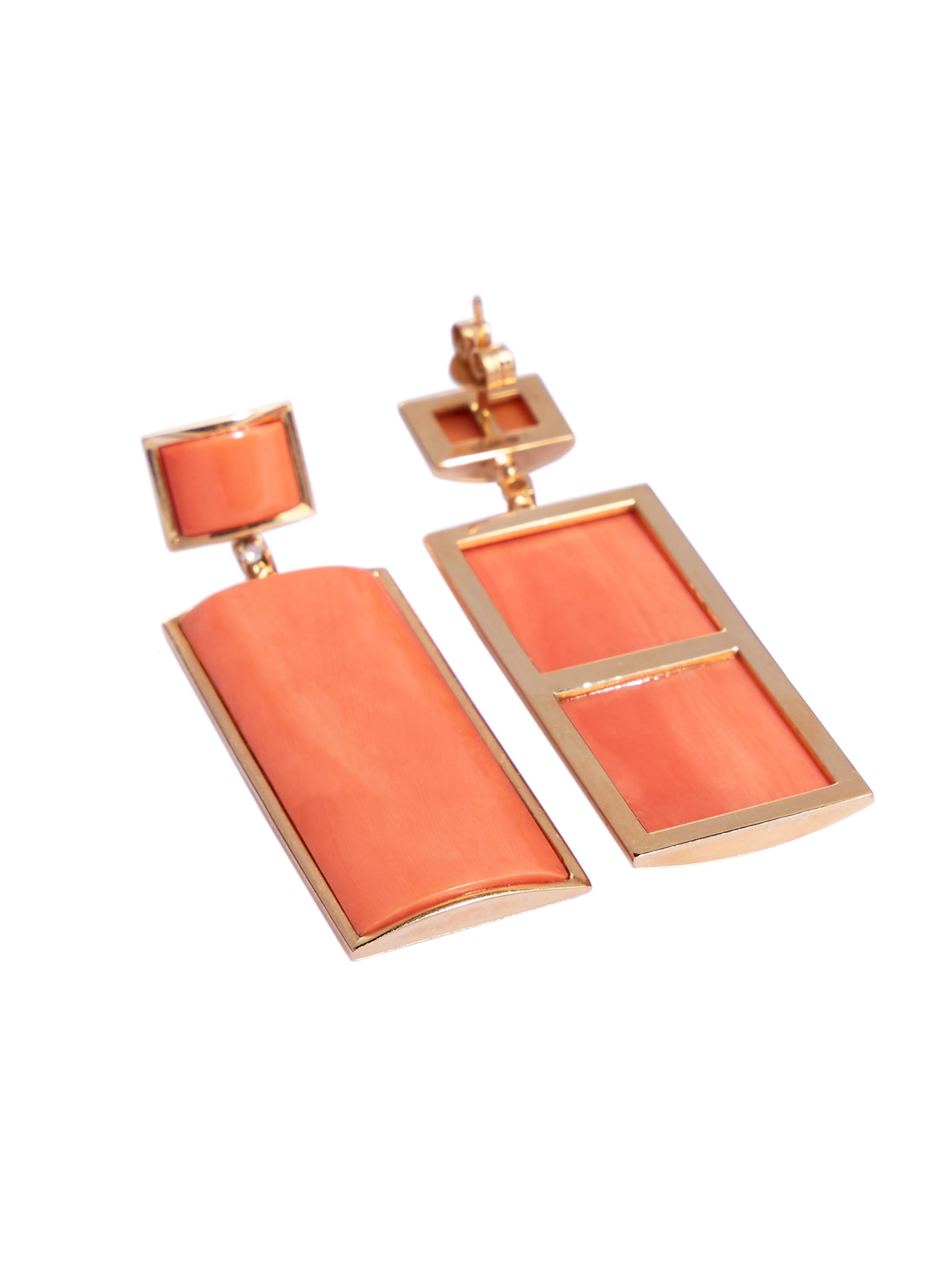 The main attraction of the earrings is the large size high quality polished bright color rectangular domed corals measuring 35.8 x 16 mm. 
The 4 natural corals are bezel set in 18 karat gold. A small diamonds connects the 2 coral elements of each