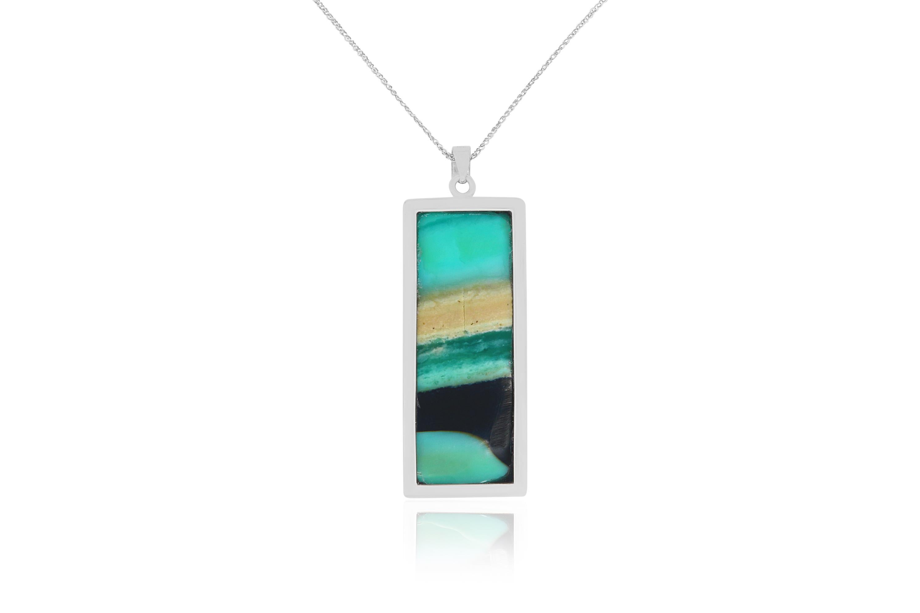 This unique elongated Opal stone features vivid turquoise, black and tan hues!

Material: 14K White Gold
Center Stone Details: 1  Opal
Chain:  18 inch

Fine one-of-a-kind craftsmanship meets incredible quality in this breathtaking piece of