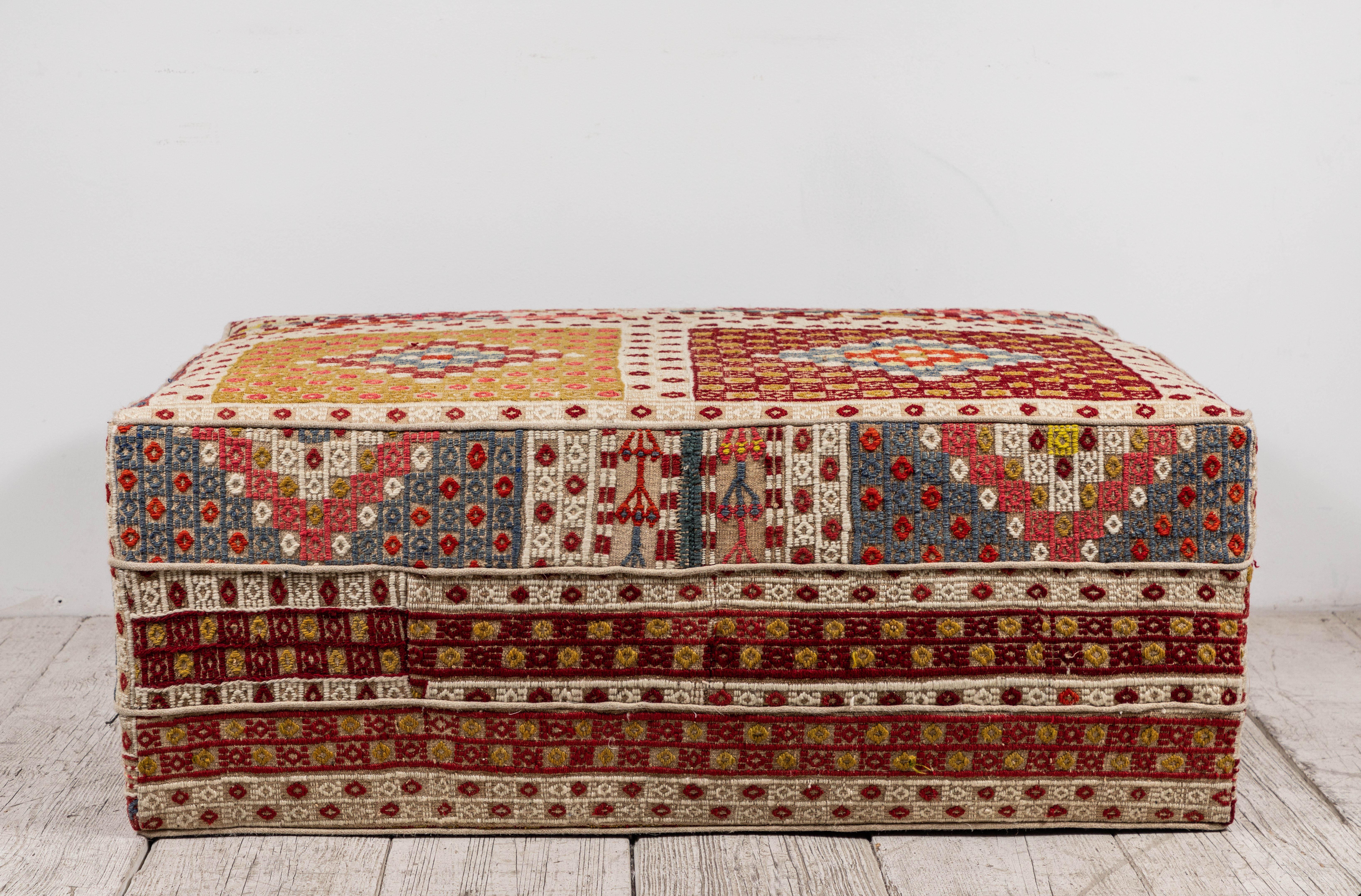 Rectangular Ottoman upholstered in a colorful vintage Turkish rug.