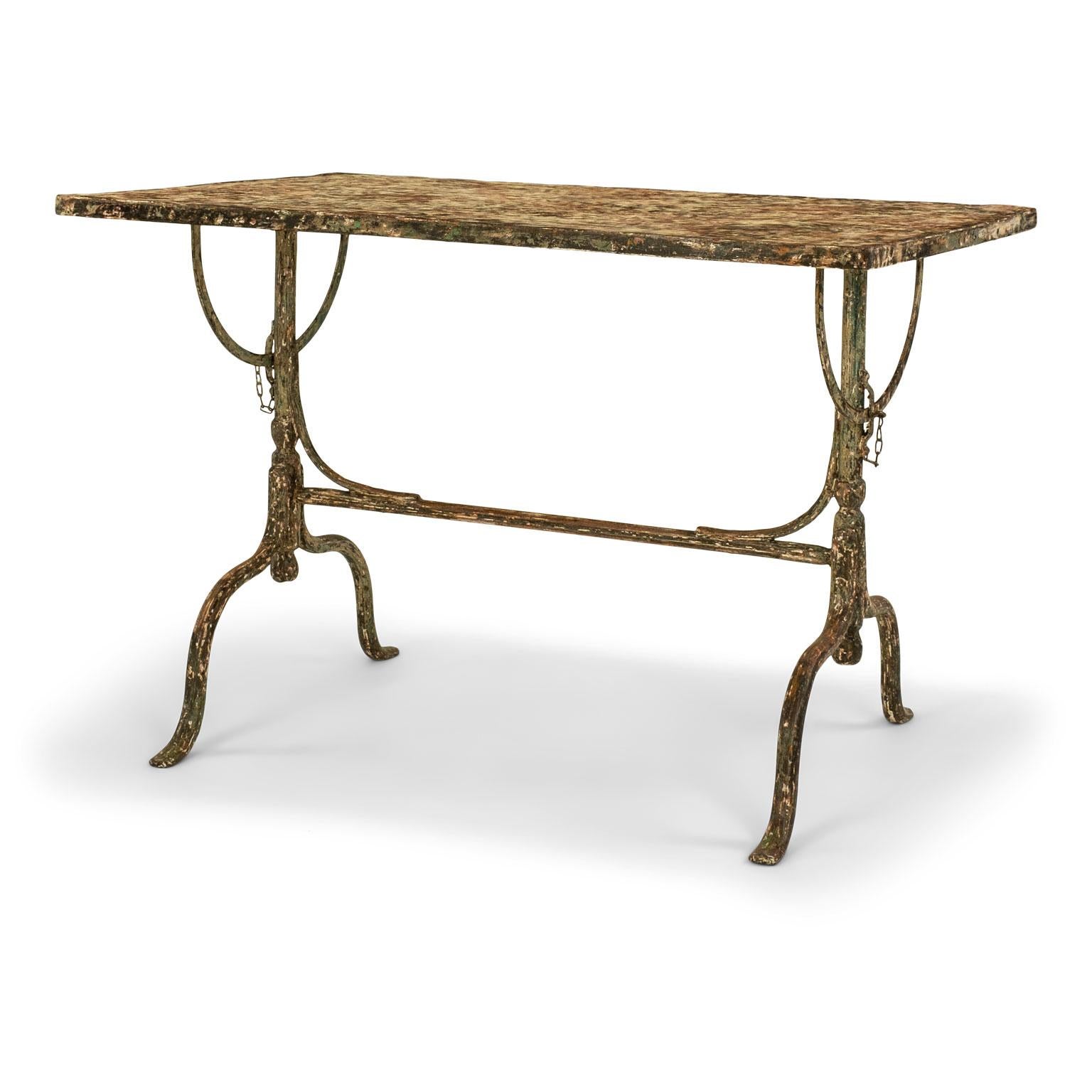 Rectangular painted iron tilt-top: late 19th century iron garden table. Rectangular steel top upon cast iron trestle base. Scraped to old painted finish. Top tilts upright for easy storage.

Note: Original/early finish on antique and vintage metal