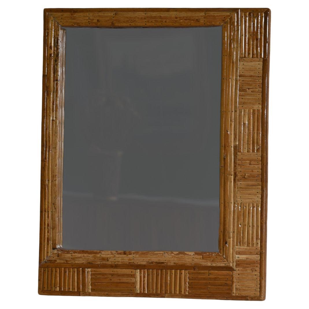 Enhance your home decor with this lovely handcrafted rectangular wall mounted mirror. The frame features a unique patterned design using organic rattan cane, adding a touch of elegance and natural beauty to any room. A lovely addition to any space,